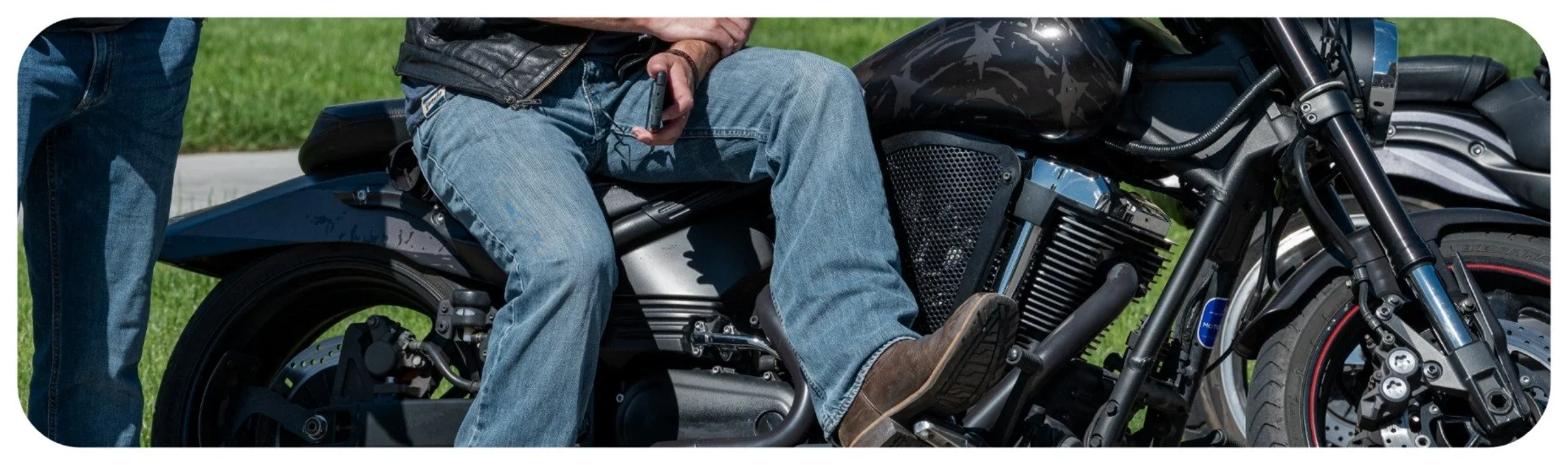Motorcyclist seated on a motorcycle after a roadway incident, representing Iowa motorcycle accident injury claims.