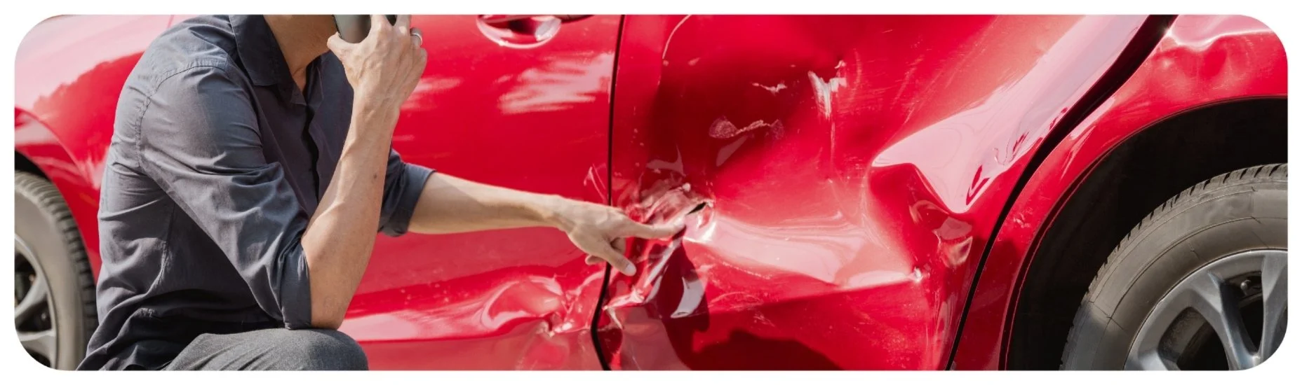 Driver inspecting damage to a car after a collision while calling for help, representing Iowa hit-and-run accident cases.
