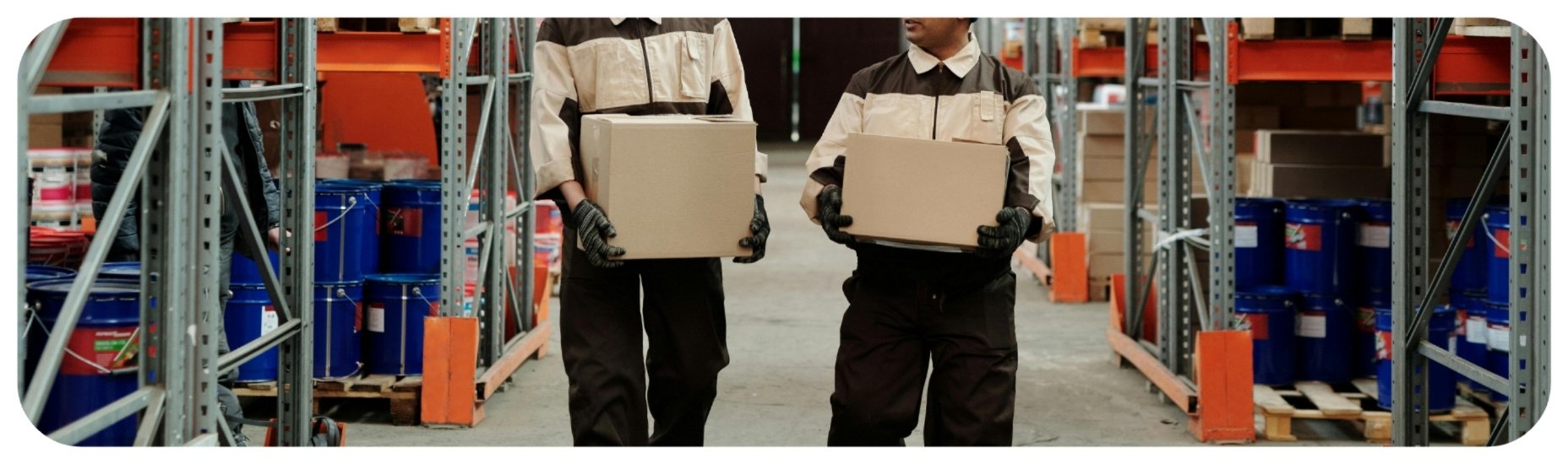Warehouse workers carrying heavy boxes, representing Iowa coworker gross negligence cases involving unsafe lifting and reckless workplace conduct.