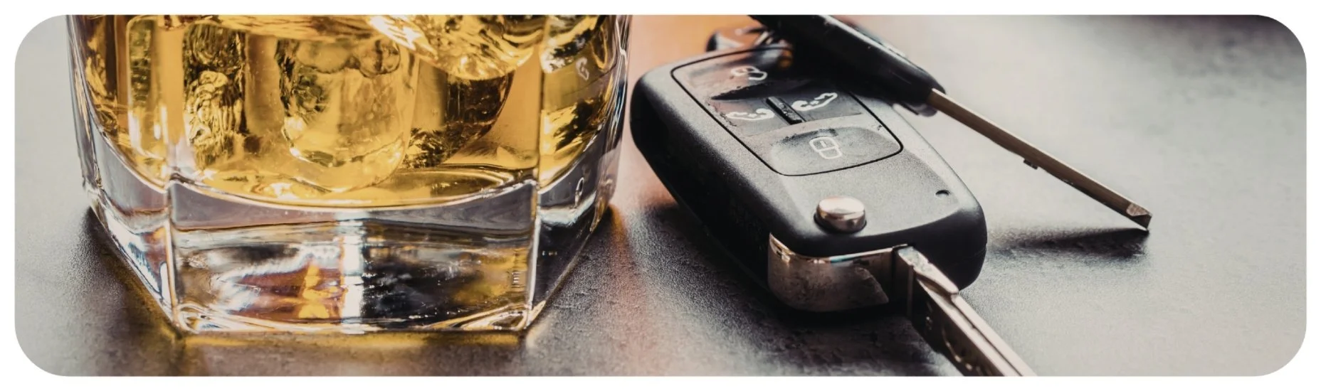 Glass of alcohol next to car keys, representing Iowa drunk driving and DUI accident injury cases.
