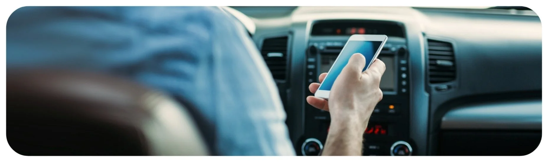 Driver using a phone behind the wheel, representing Iowa distracted driving and texting-while-driving accident cases.