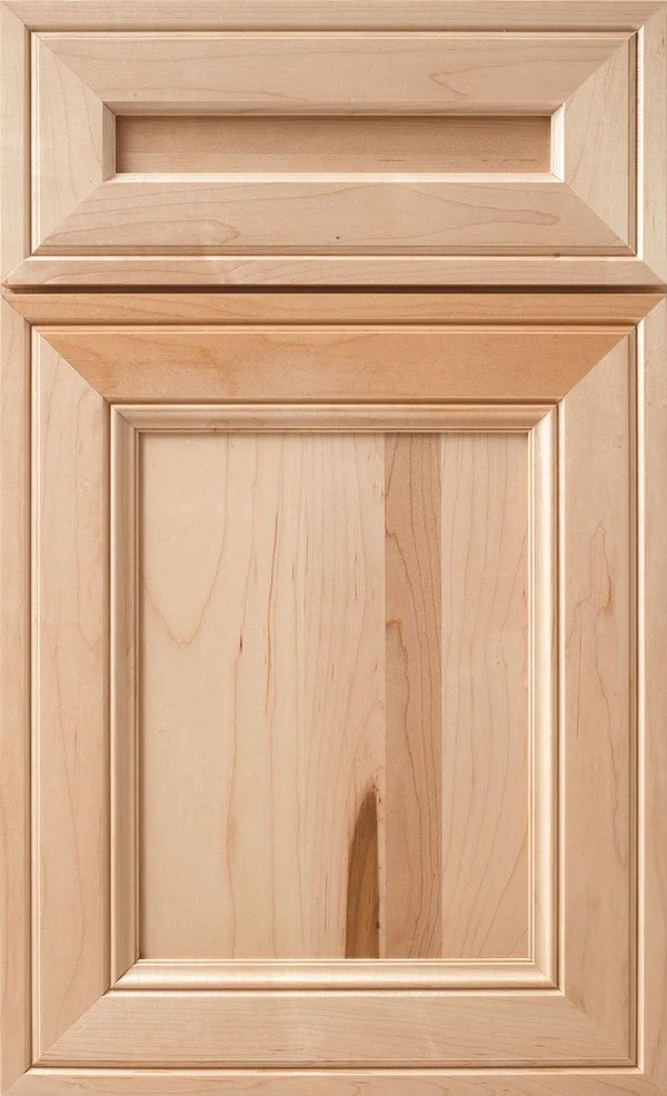 A light-colored wooden cabinet door with a rectangular panel design and decorative molding.