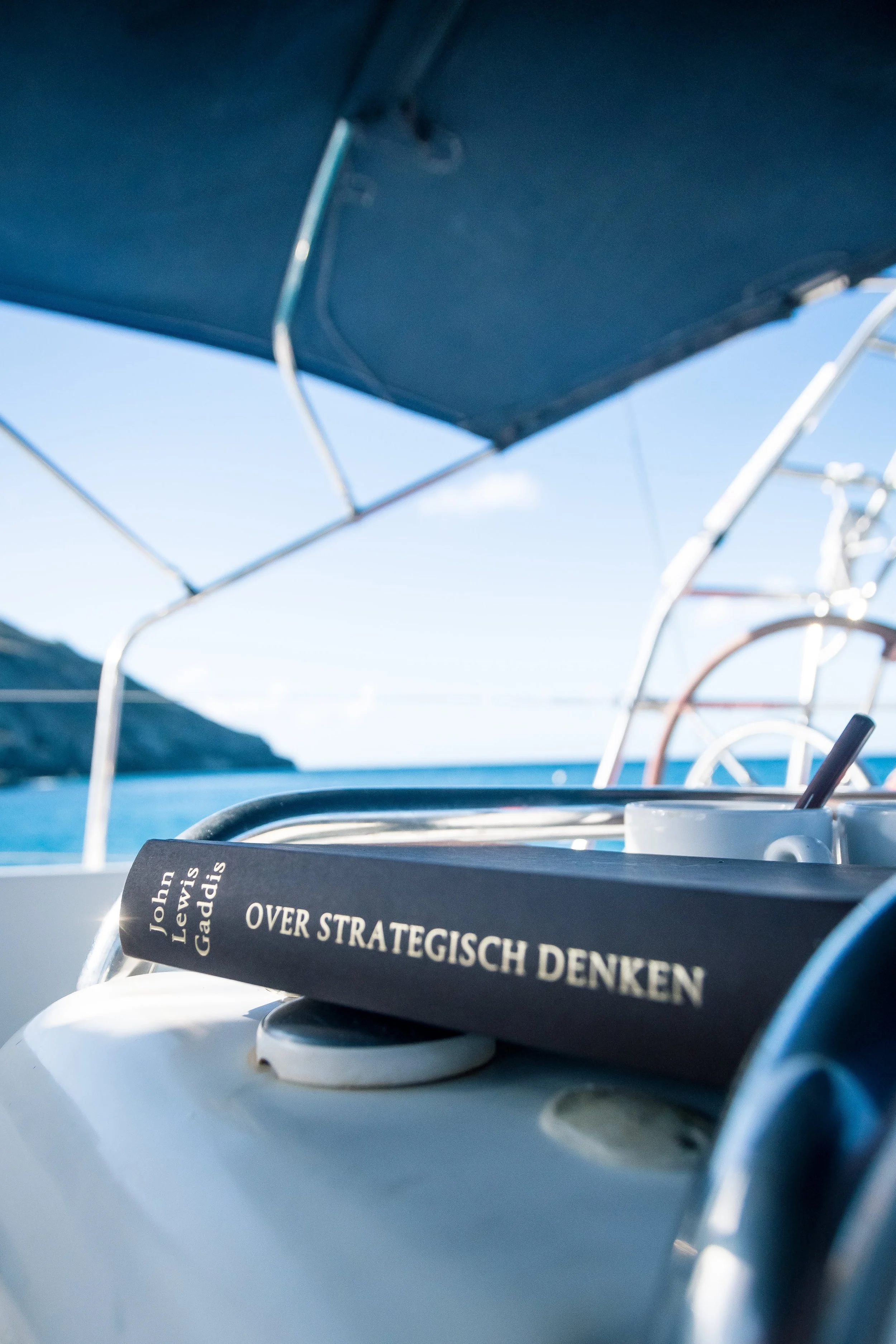 Book on the helm of Spirit of Ostend during a leadership voyage along the Irish Atlantic coast.