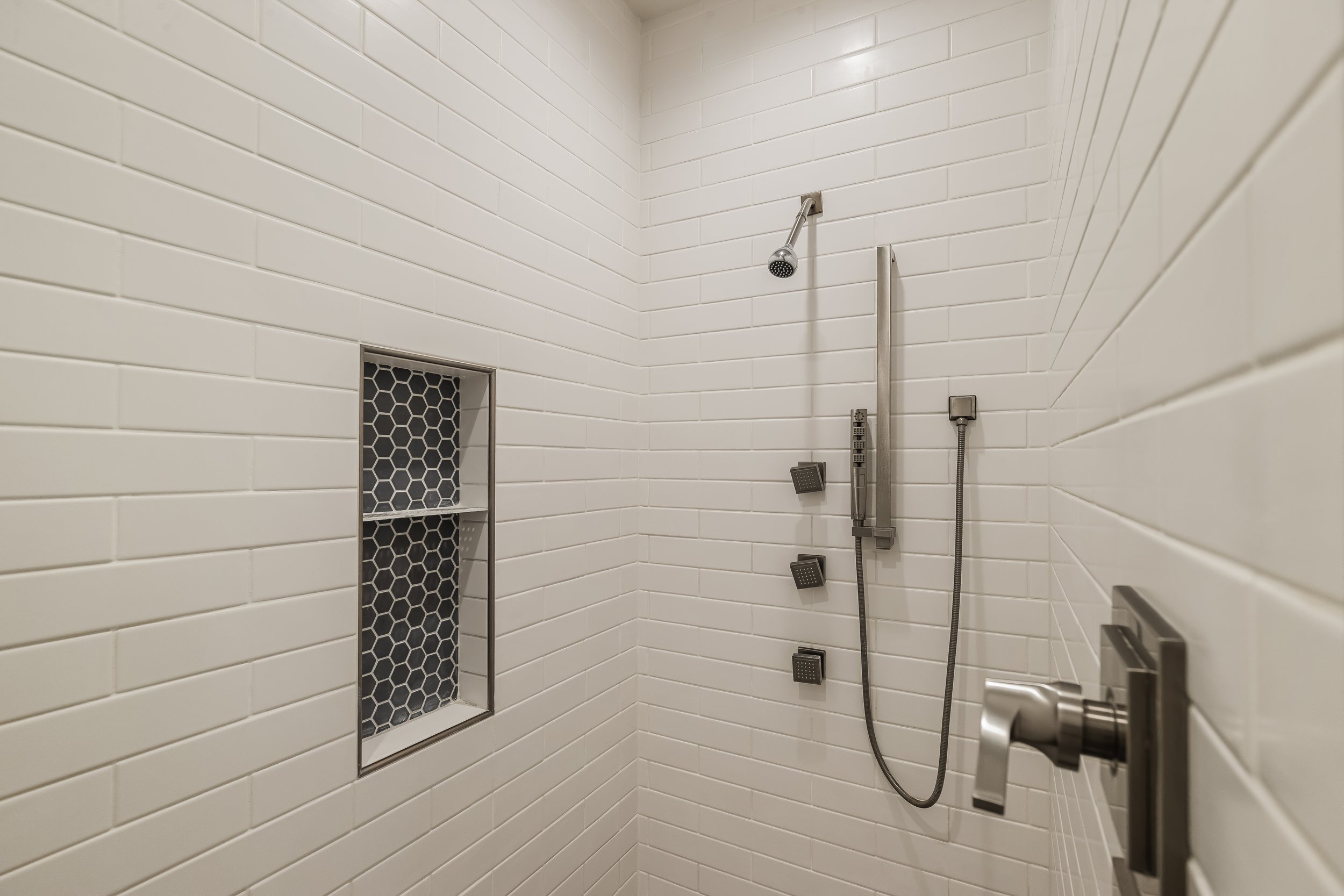 Tiled walk-in shower in the primary bathroom