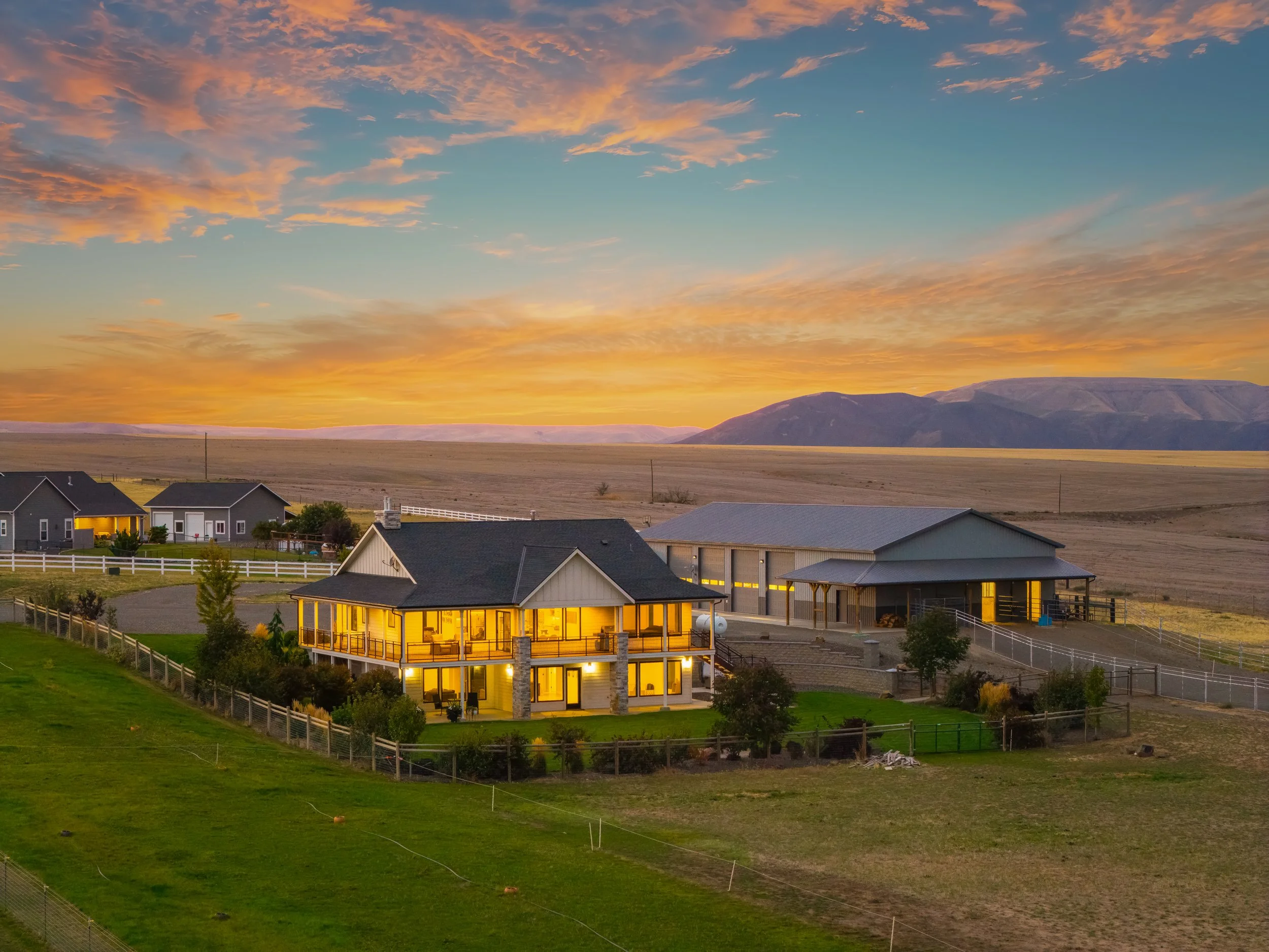 Twilight aerial of 1433 Kestrel Dr, a 5-acre horse property in Clarkston WA