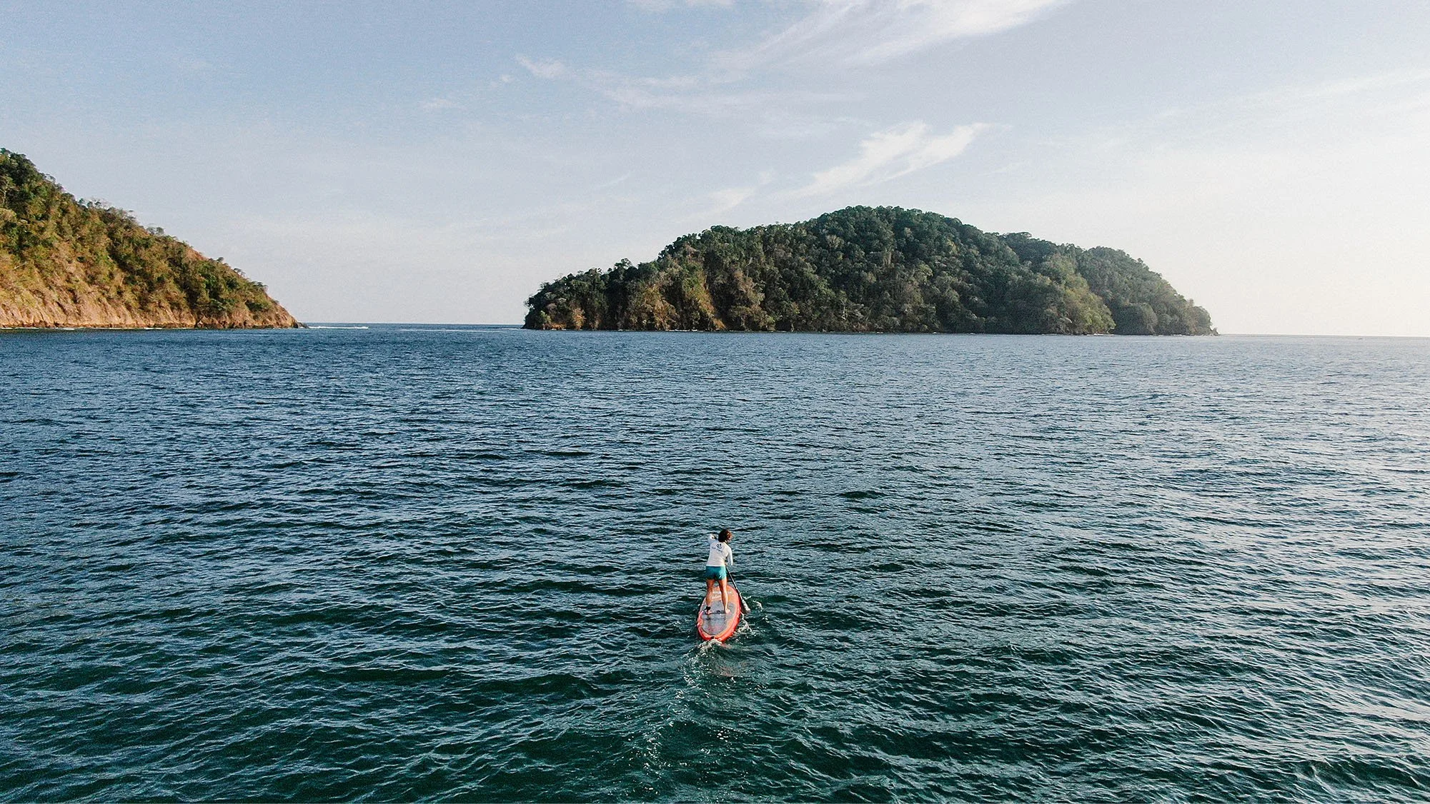 surf-synergy-guest-standup-paddleboarding-in-pacific-warm-waters.jpg