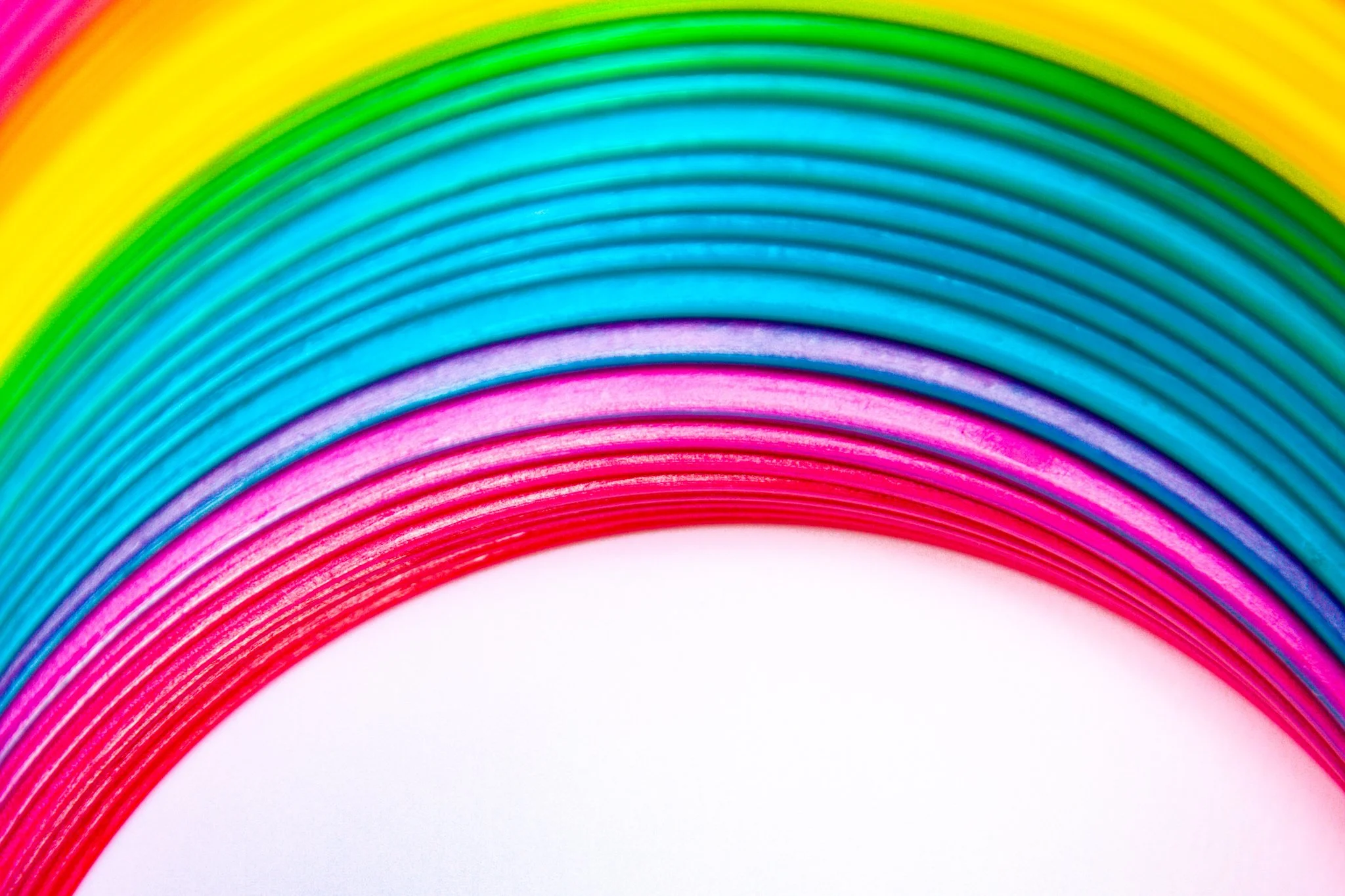 Colorful rainbow and rainbow-colored pencils arranged in an arch