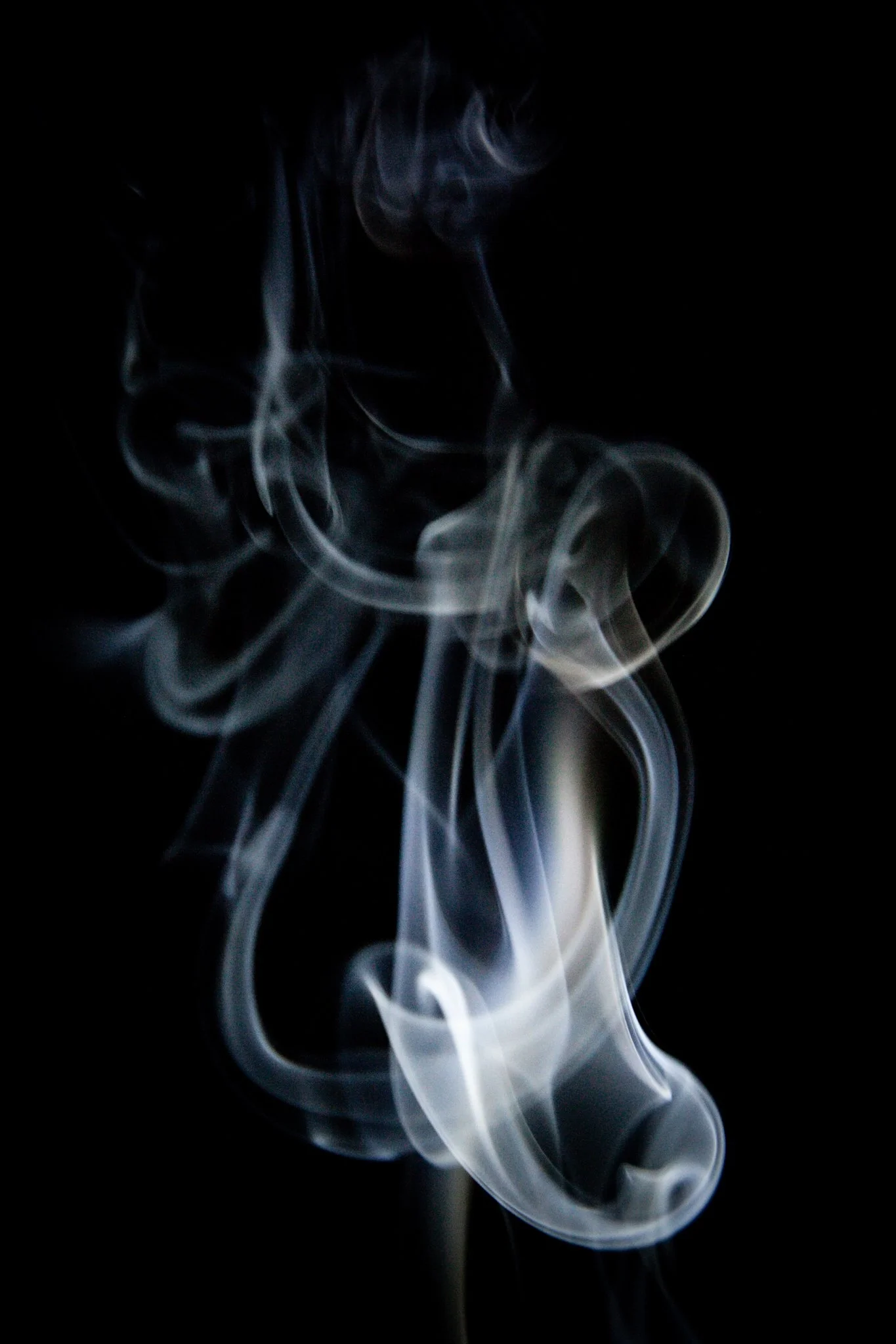 Wavy, white smoke against a black background.