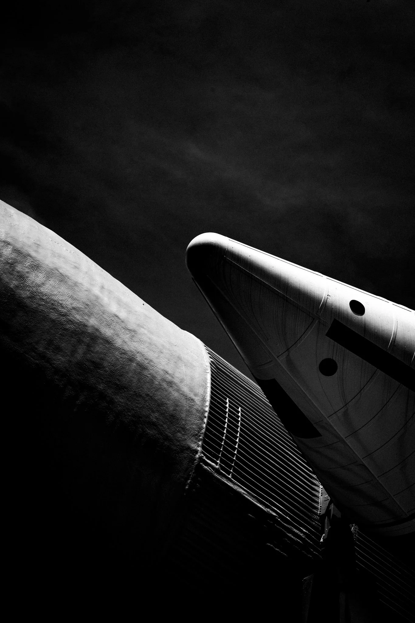 A spacecraft or satellite orbiting Earth, with the planet’s surface partially visible and the space above in darkness.