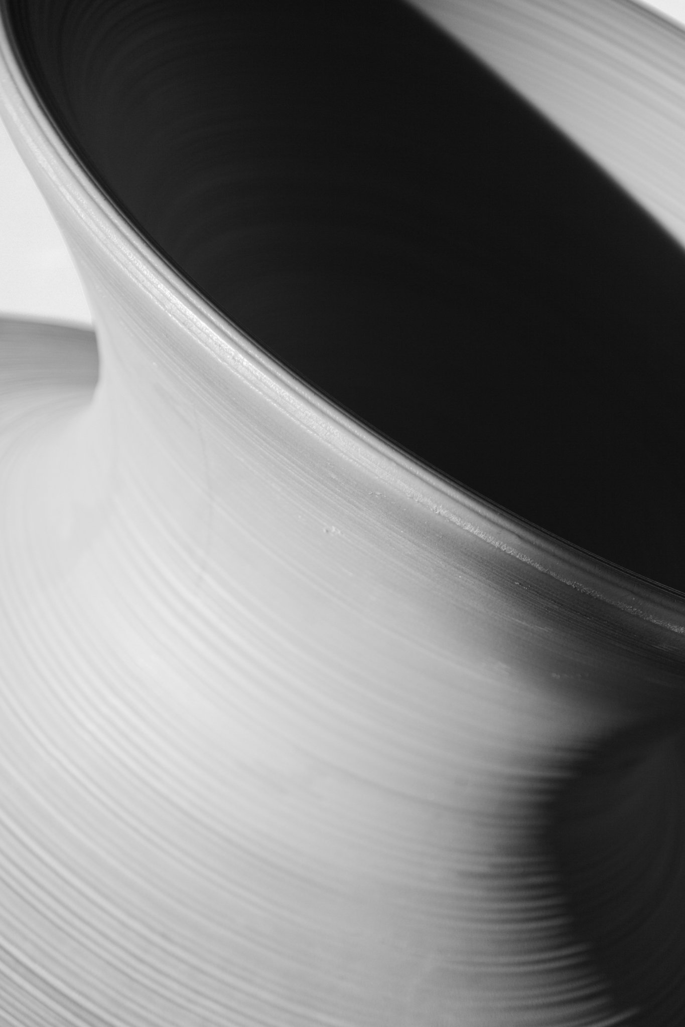 Close-up of a black vinyl record on a turntable with grooves visible on its surface.