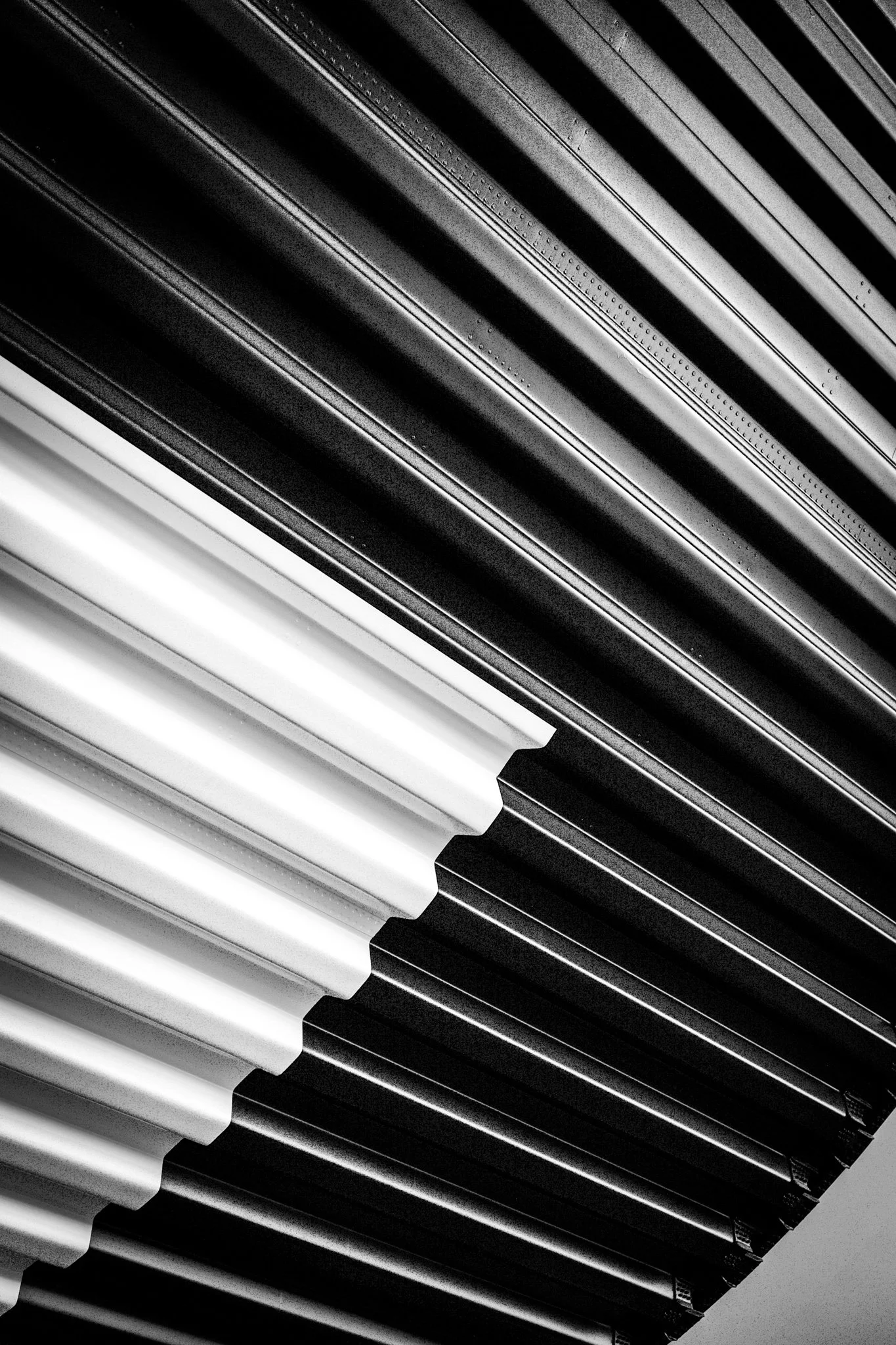 Close-up photo of piano keys, alternating between black and white keys, in a diagonal layout.
