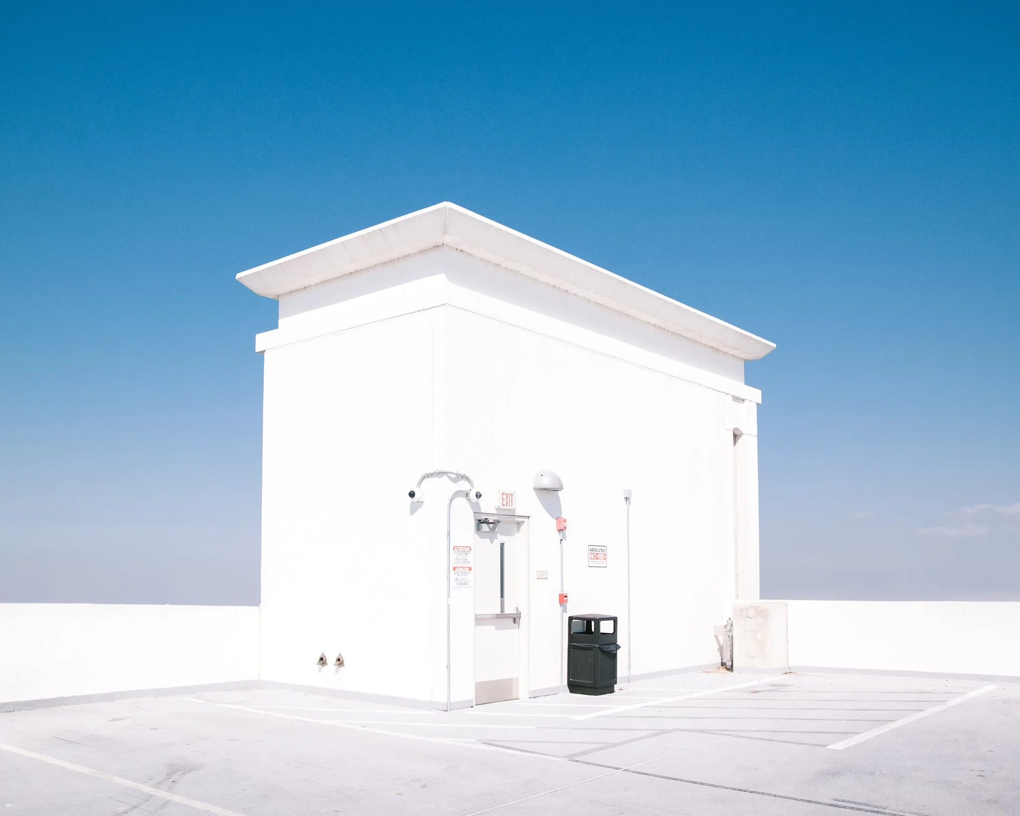 White building with a sharp roof against a clear blue sky