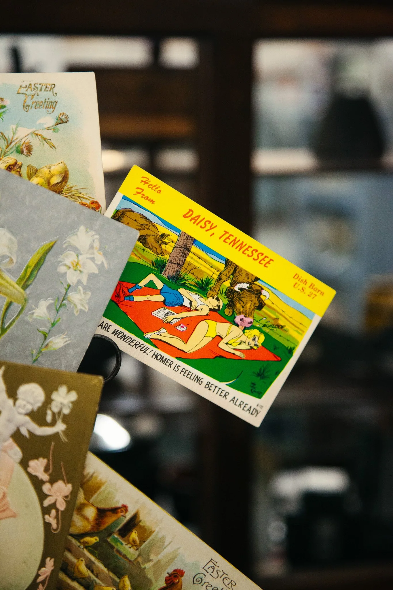 Colorful  postcard for Soddy Tennessee hanging on a display stand.