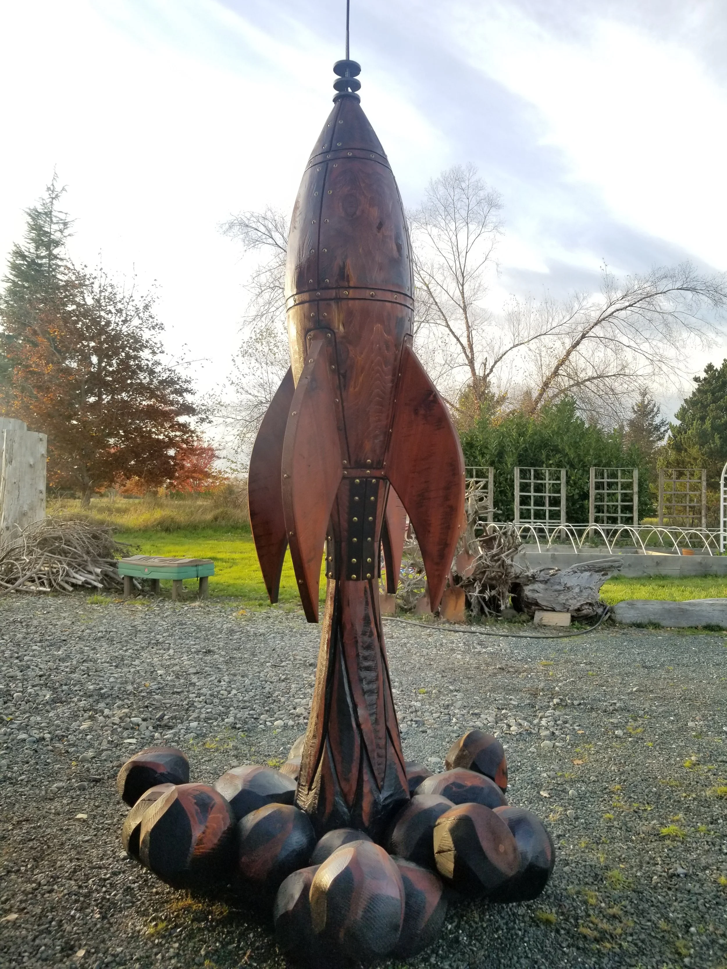 Chainsaw sculpture of wood rocket by Tomas Vrba of Bellingham WA