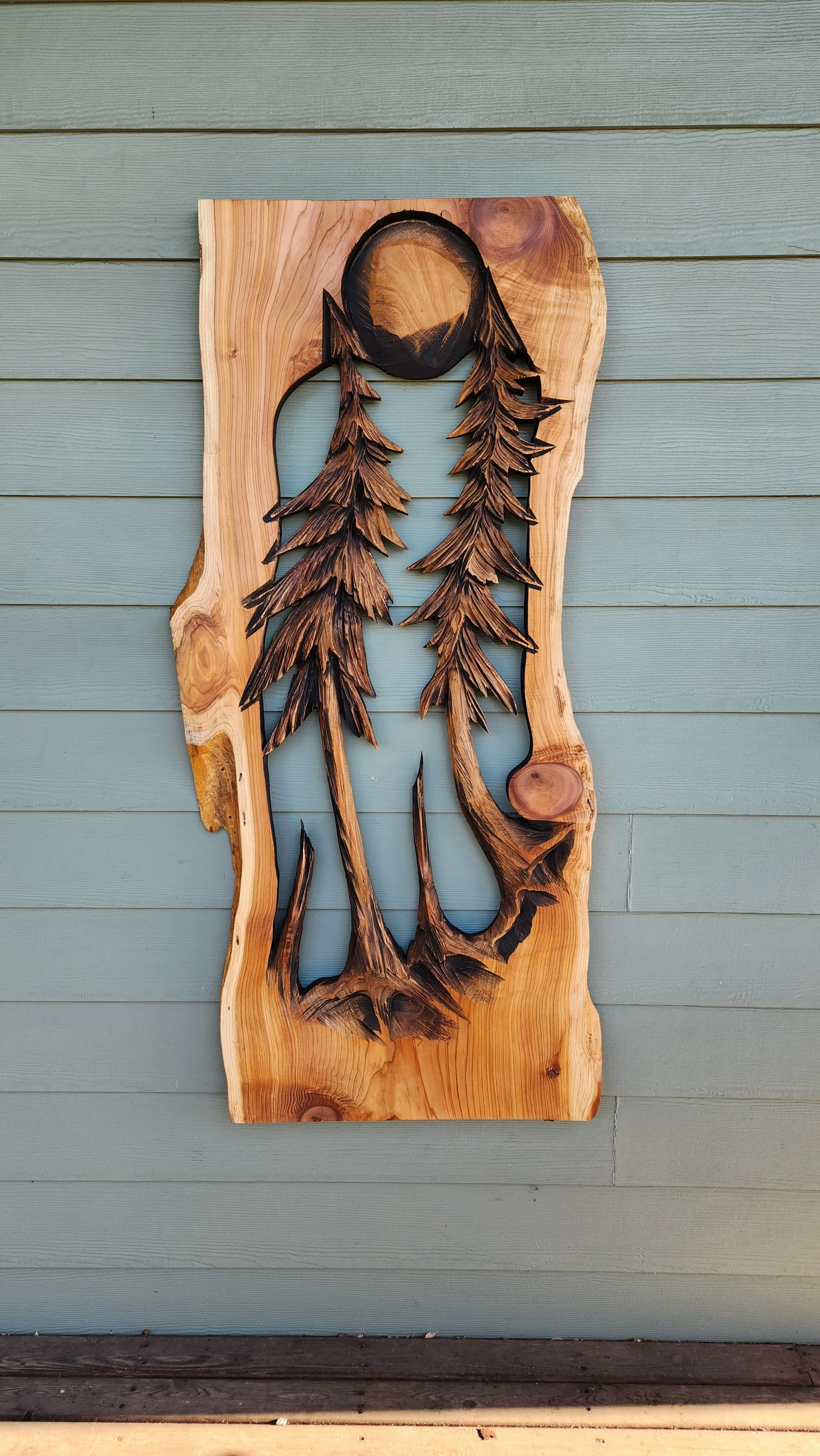 Trees in relief with live edge by chainsaw sculptor Tomas Vrba of Bellingham, WA