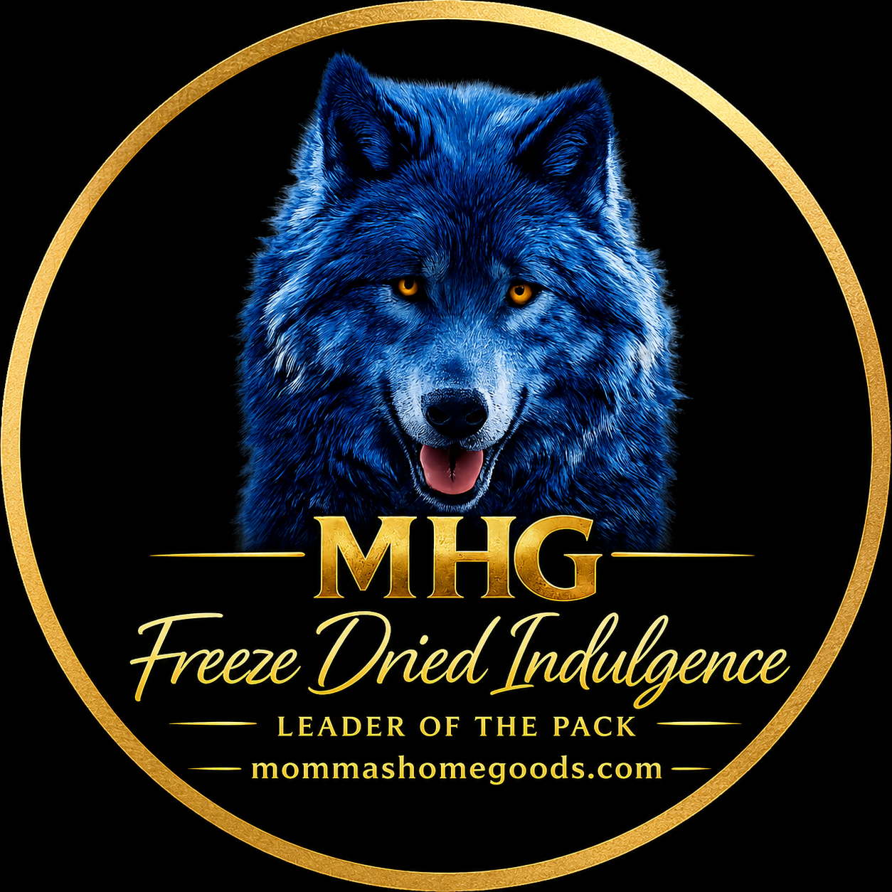 A graphic logo featuring a realistic, blue wolf with yellow eyes and an open mouth. The wolf is framed by a gold circle with the text "MHG" in gold, below which is the phrase "Freeze Dried Indulgence" in cursive, and "Leader of the Pack" in smaller all caps. The website "mommashomegoods.com" appears at the bottom.