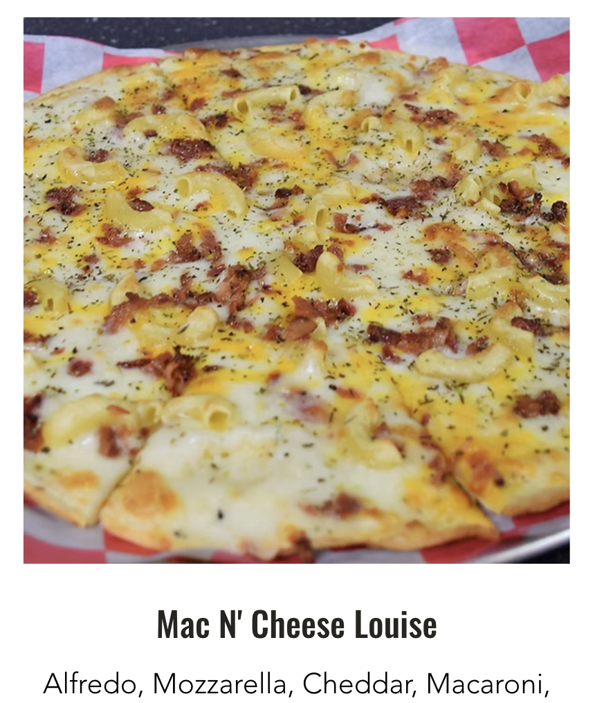 A close-up of a pizza topped with cheese, bacon bits, and herbs, served on a red checkered paper.