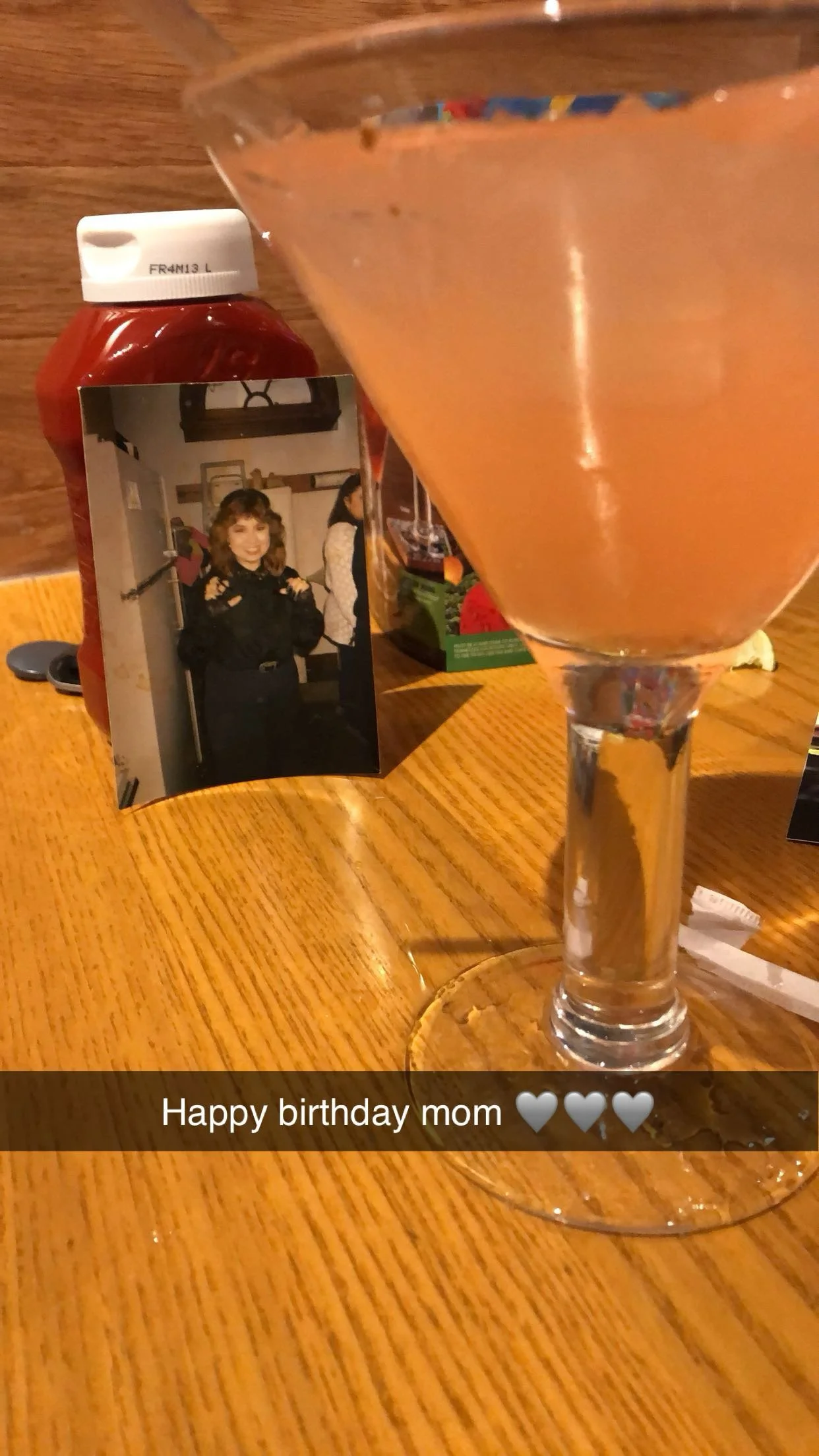 picture of a mom propped up on a ketchup bottle witha margarita