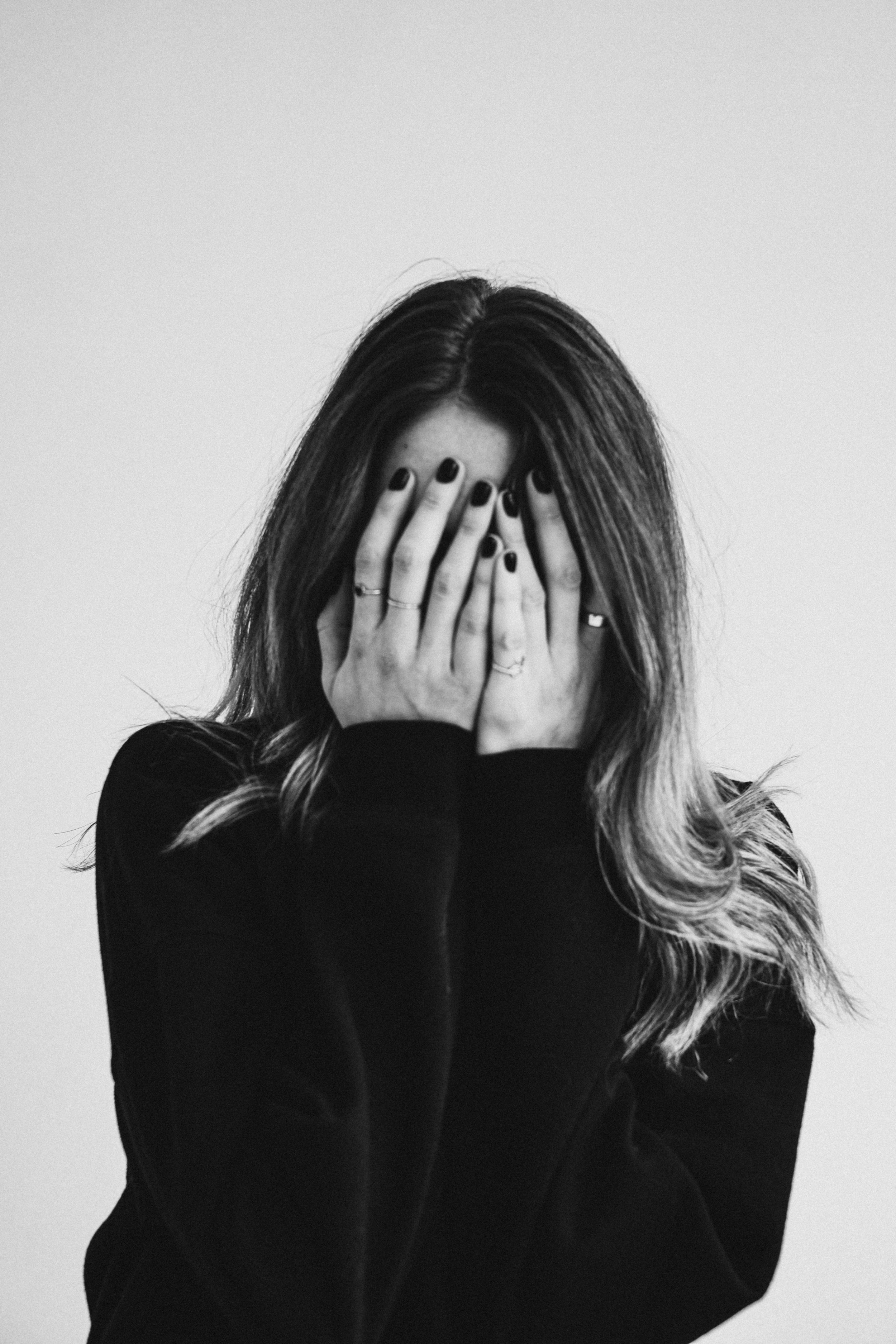 woman with hands over her face