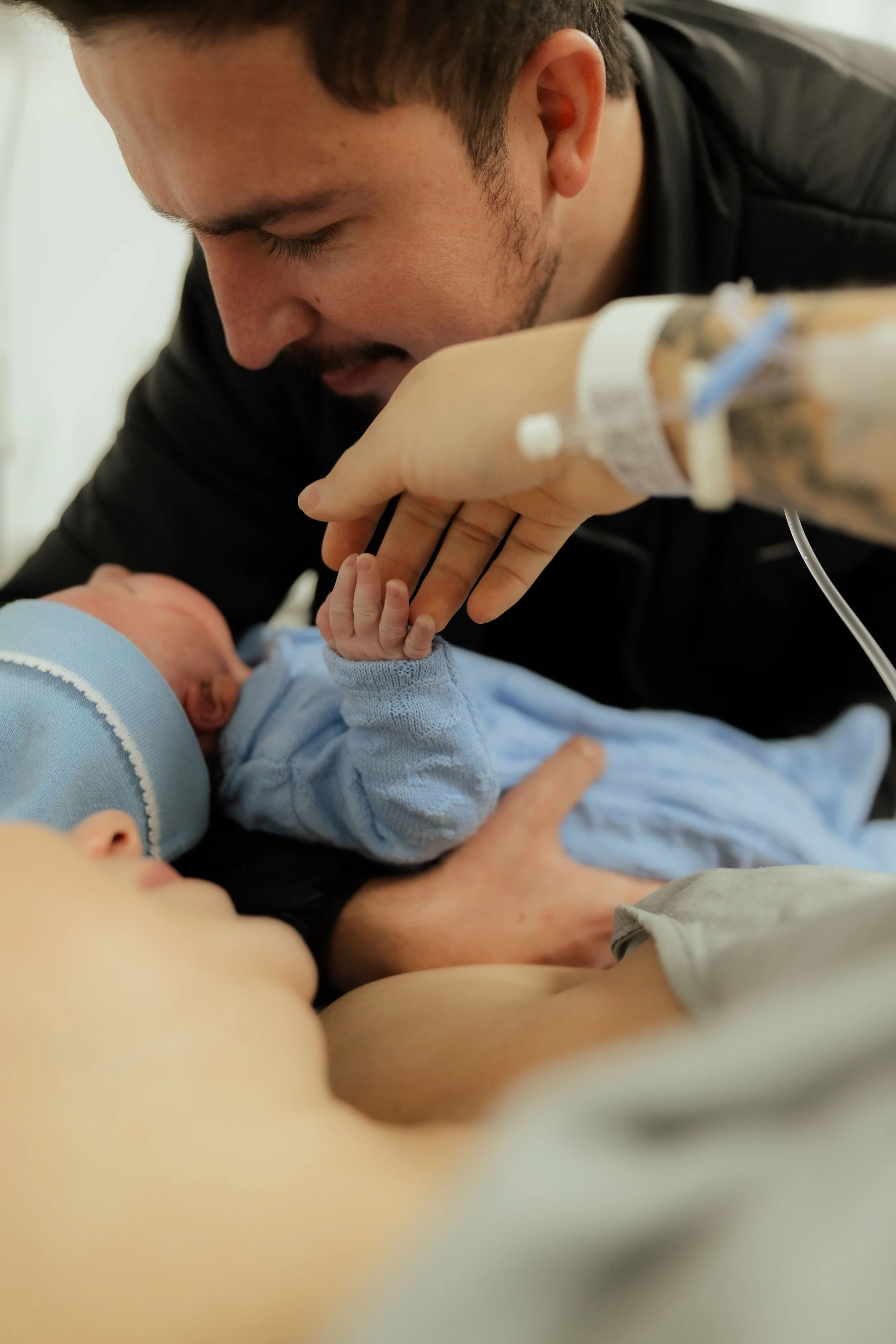 father holding new baby
