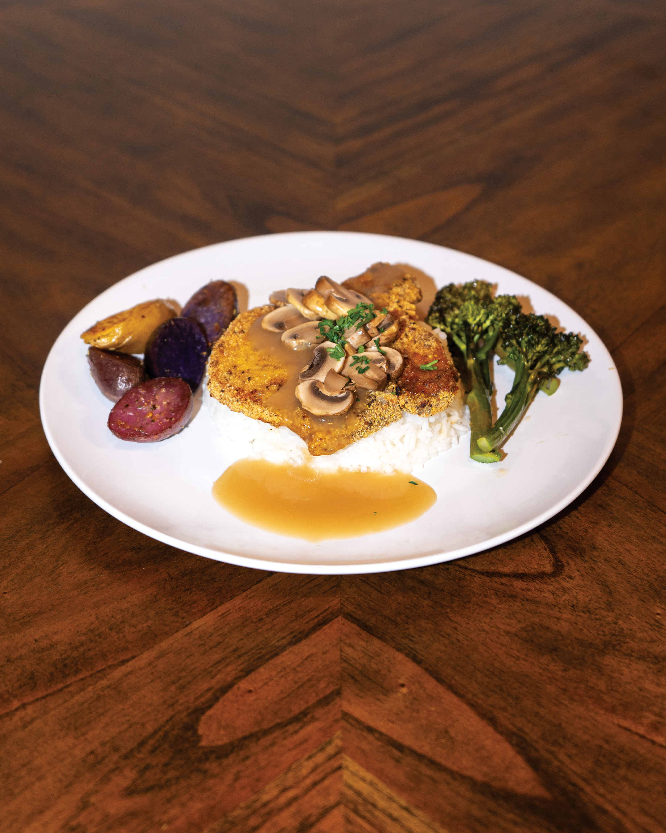 Corn Meal Fried Center Cut Pork Chop, Over Jasmine White Rice Smothered in Gravy With Roasted Broccolini 