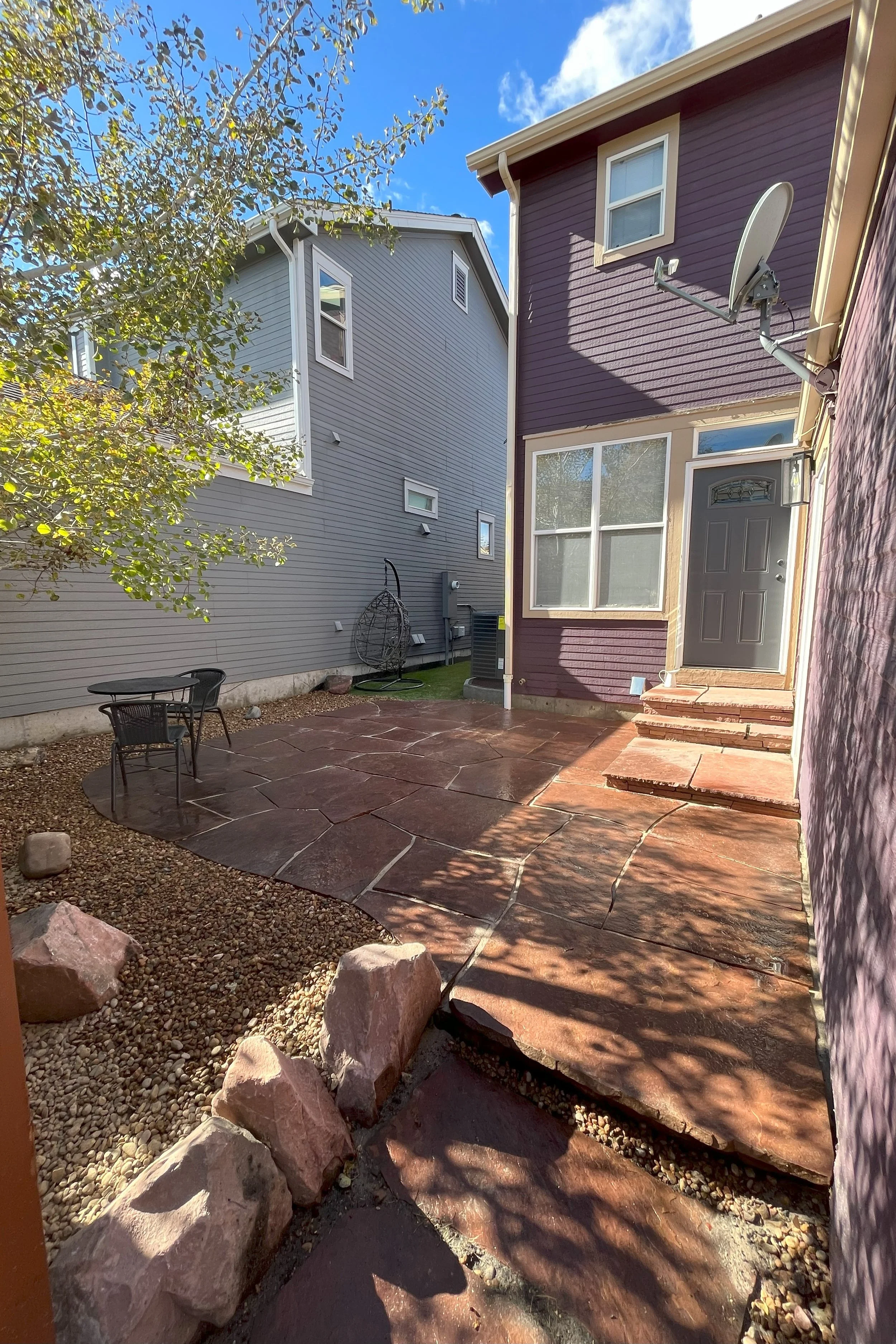 Flagstone Makeover: Weed Barrier and River Stone

We took on the task of revamping the space by adding a weed barrier, installing artificial turf along the side of the house, and replacing the existing rock with 2 tons of fresh, high-quality 3/4" riv