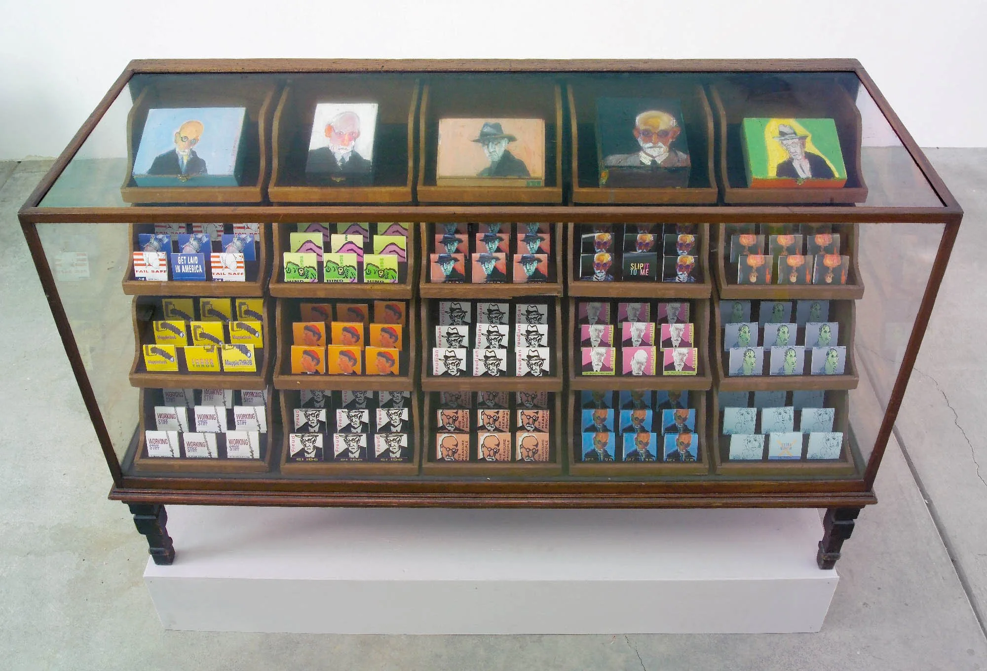 Freud’s Pharmacy, 2004, condoms, painted cigar boxes in antique display, 38 x 36 x 60 in.