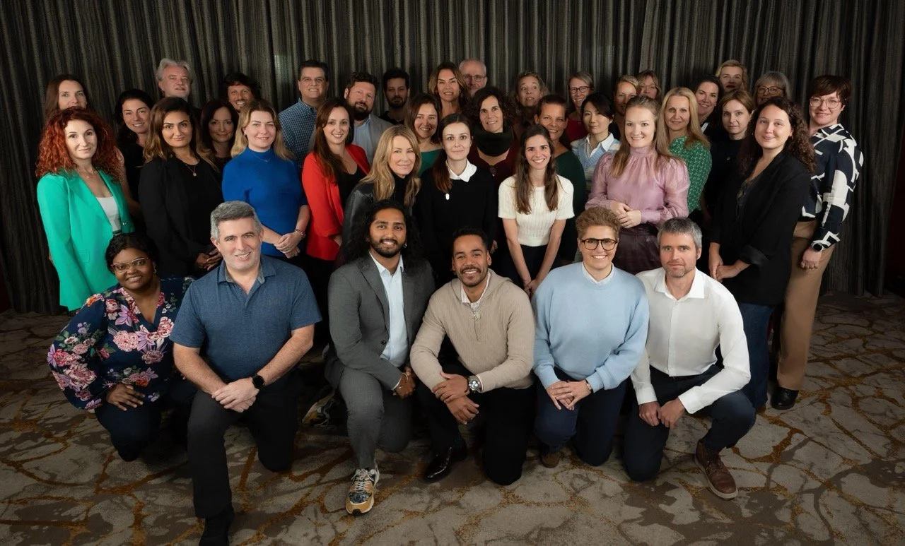 Casual portrait of conference attendees smiling outside event location