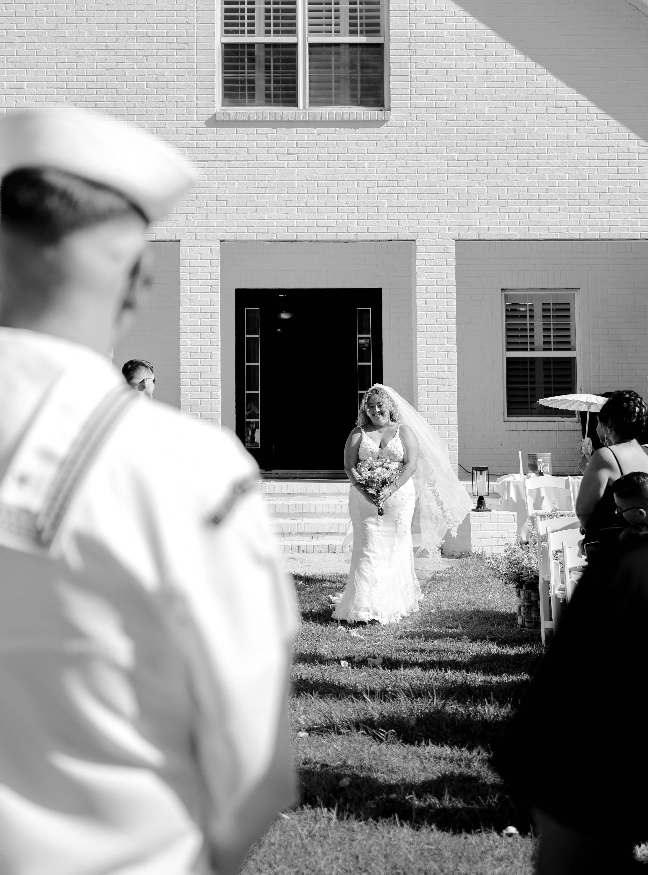 An emotional image showing a bride walking down the aisle to her awaiting husband at an Airbnb in Kingsland Georgia, captured by LUX Photo + Film