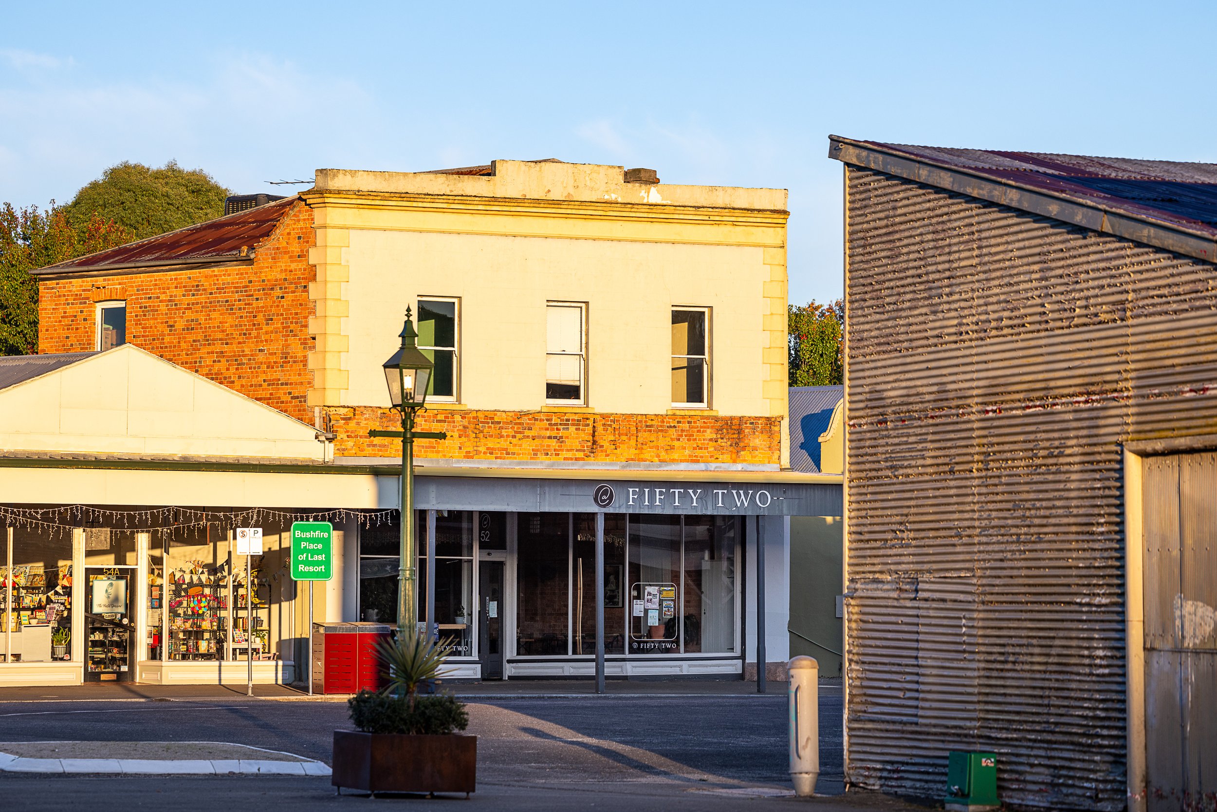 Historic bluestone building housing Café Fifty Two on Fraser Street in Clunes, Victoria.
