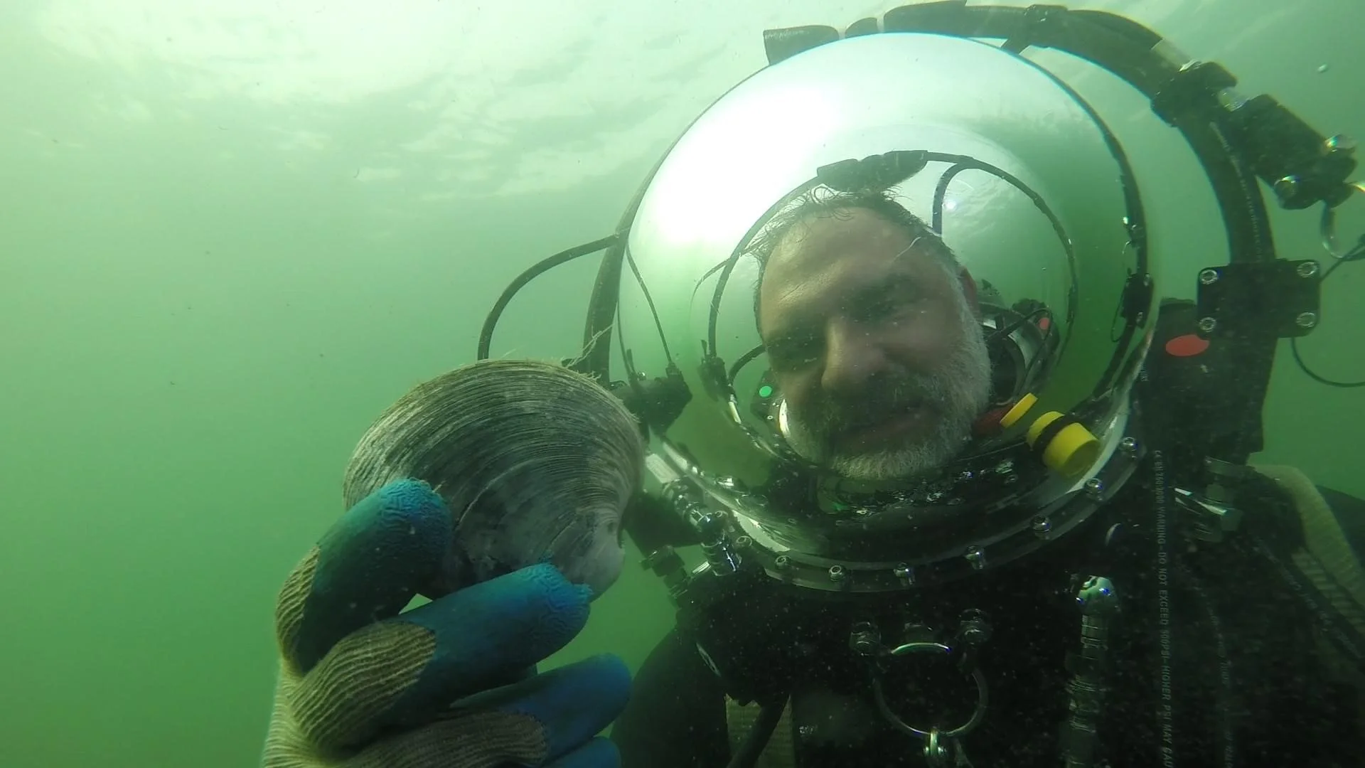 Mike Lombardi underwater in a diving suit exploring the Sakonnet River