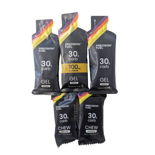 Five black energy gel packets, three labeled 'GEL' and two labeled 'CHEW', each containing 30 grams of carbs, one with 100 mg caffeine, arranged in two rows on a white background.