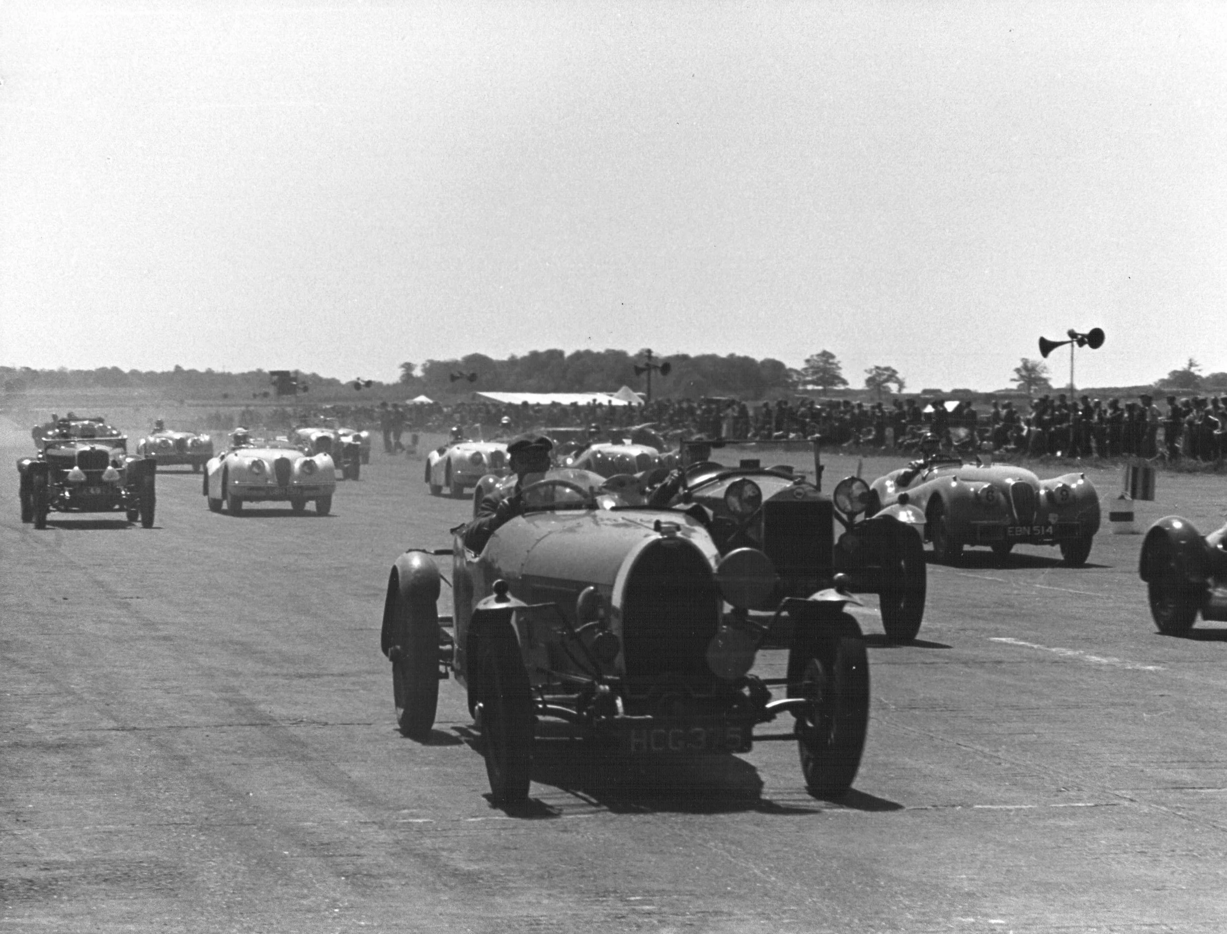 My Grandfather Racing his Bugatti at Silverstone when it first opened in 1948. The XK120's are new!