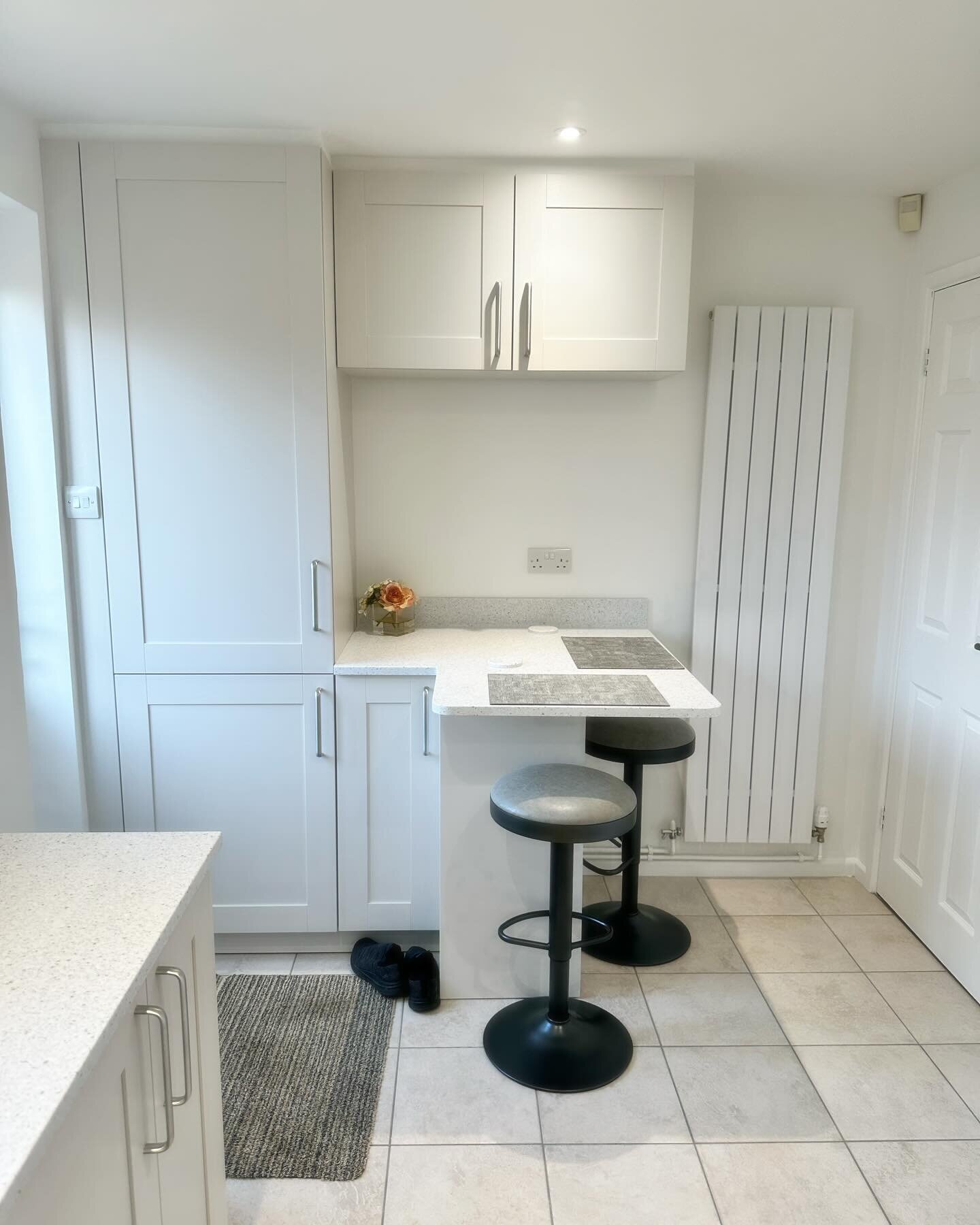 Our long standing client approached us to revamp their kitchen and add a breakfast bar area. Clever design was needed to make the most of the space which was impeded by several doors. We kept to a light colour scheme and used Corian for the worktops 