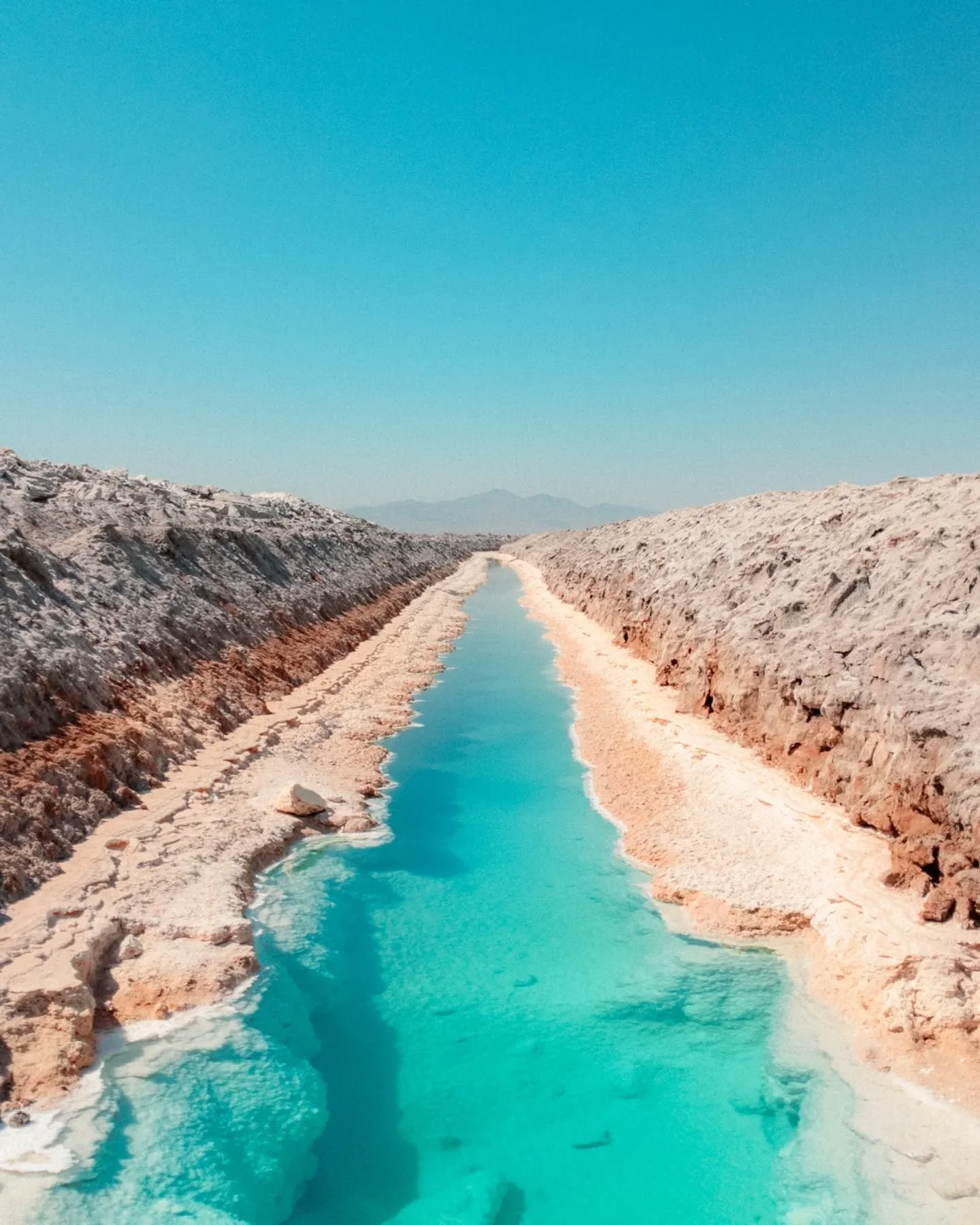 The Mojave Desert is large, desolate, and beautiful. The ground is cracked and dry, crunching underneath your feet as you walk. Here in Amboy, California, salt is mined from the underground pooling of brine. The water is crystal clear, transitioning 