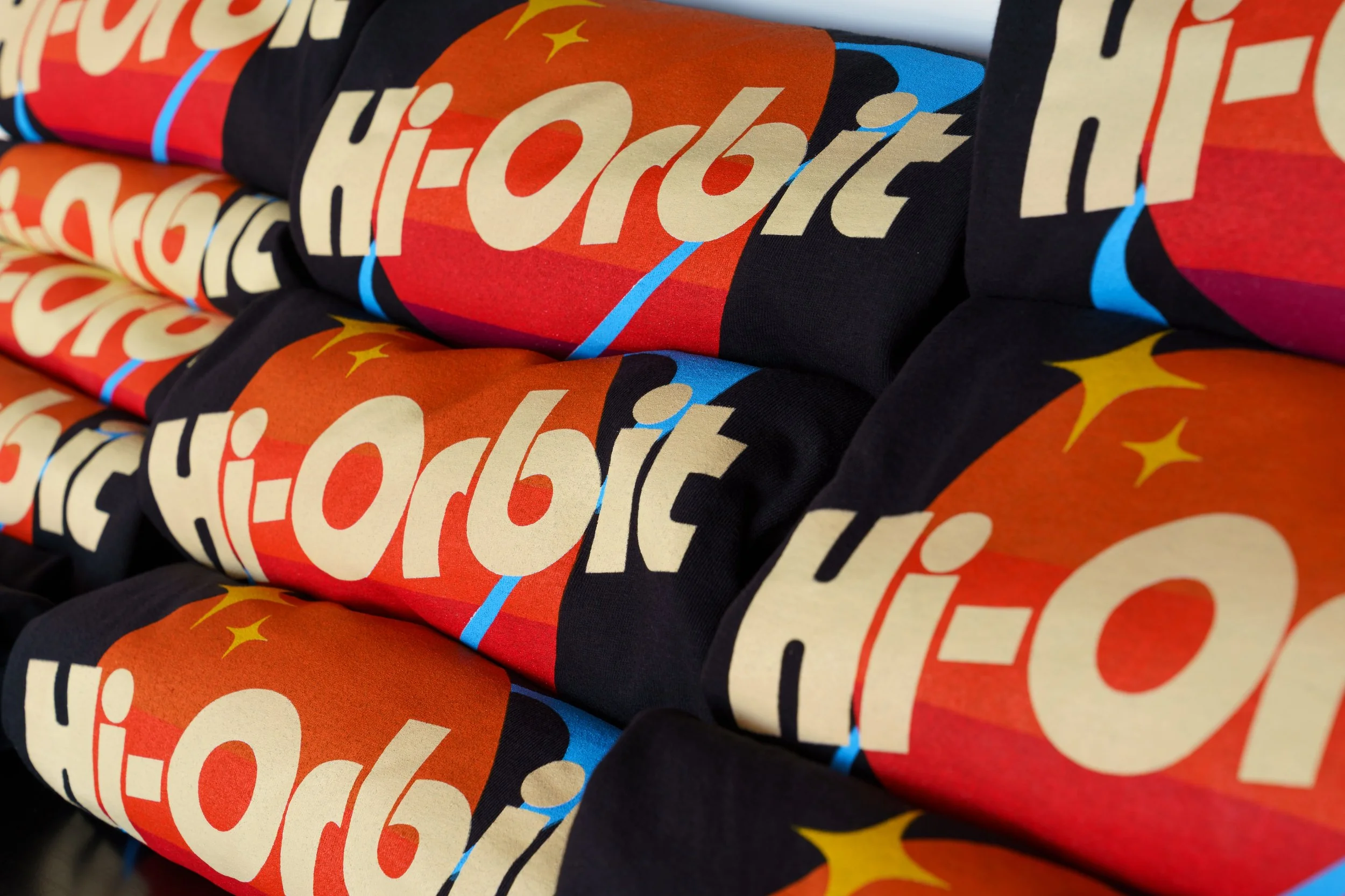Hi-Orbit Games T-Shirts Folded and Stacked on a Shelf