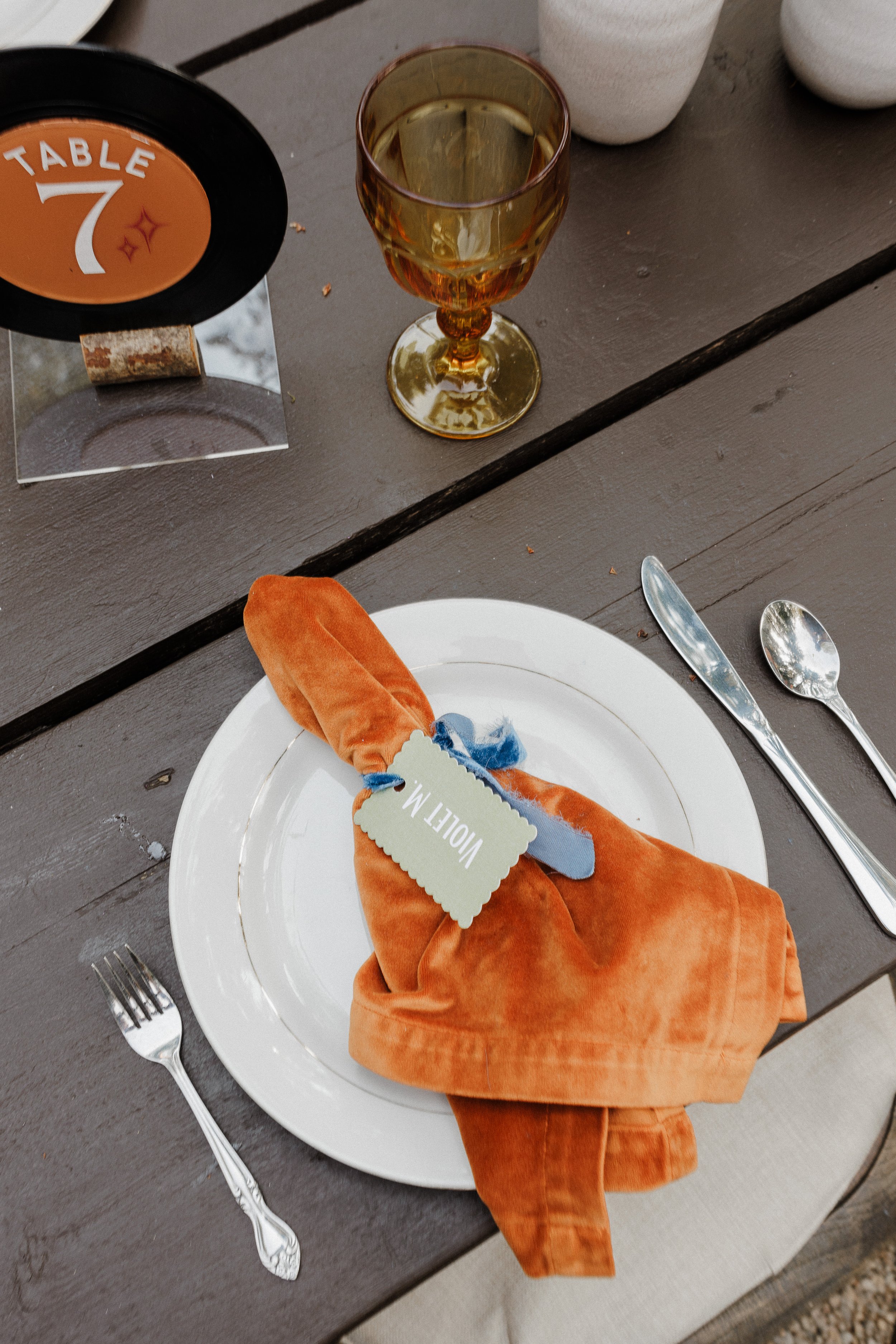 Custom wedding place cards thoughtfully tied to napkins, personalized and elegant wedding signage, unique seating arrangement ideas for weddings and receptions in Central Oregon and beyond.