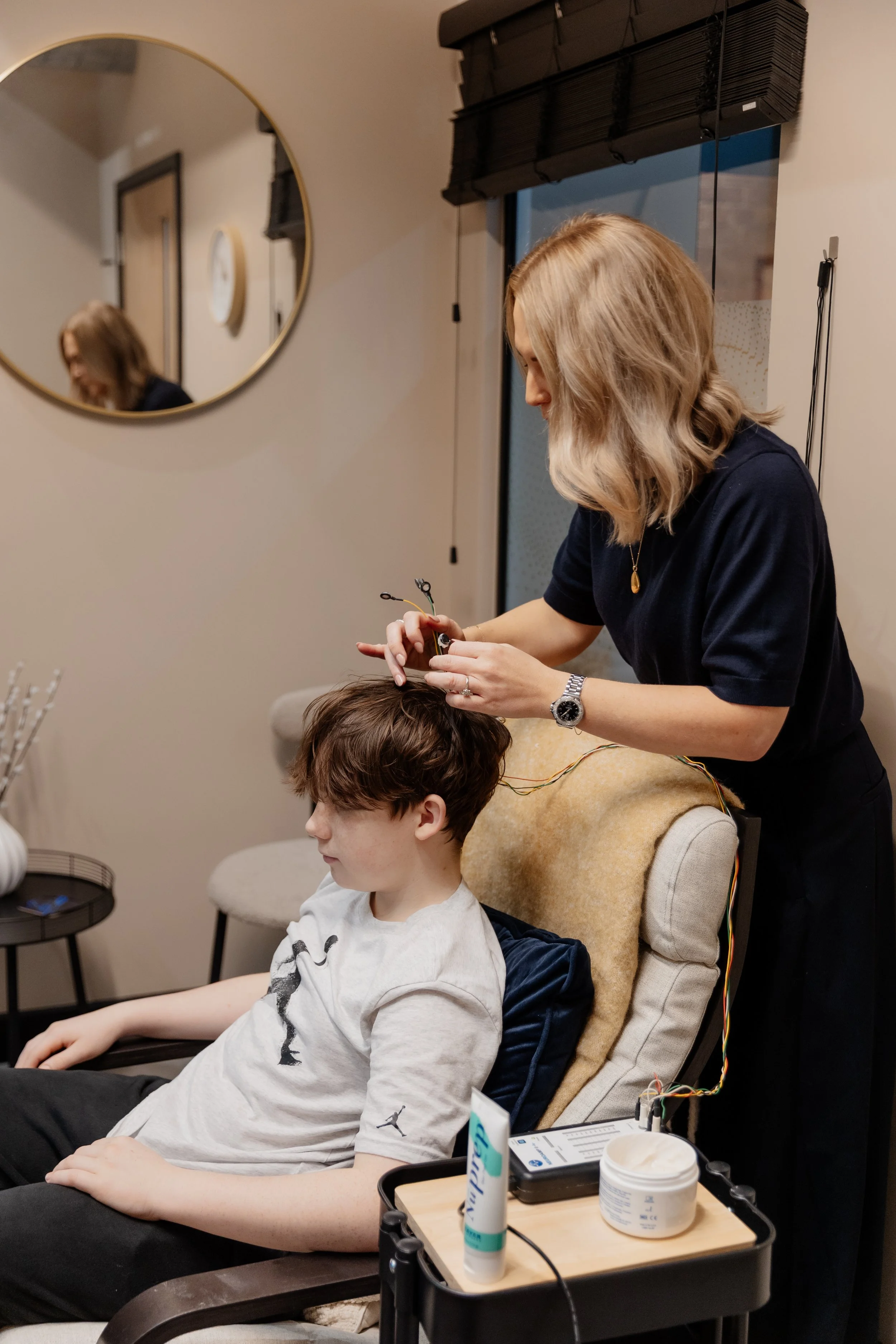 setting up a neurofeedback session with a teenage boy