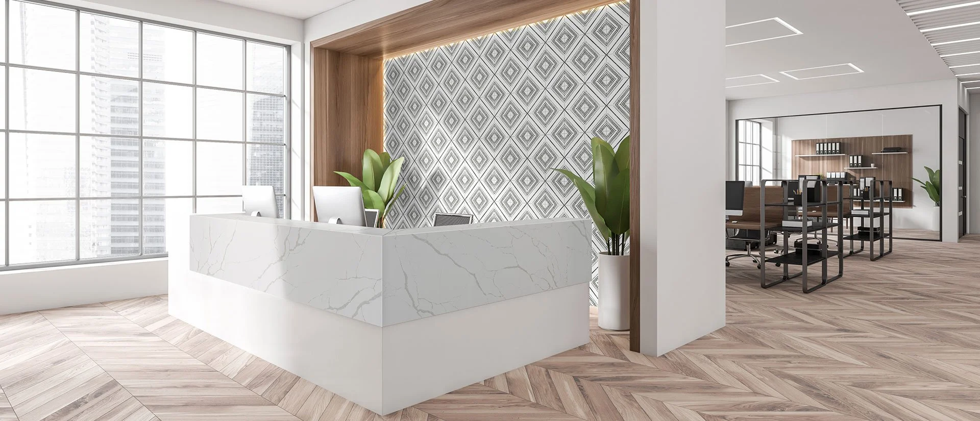 Modern office reception area with a white marble desk, large windows, patterned wall, and a meeting room with chairs and shelves in the background.