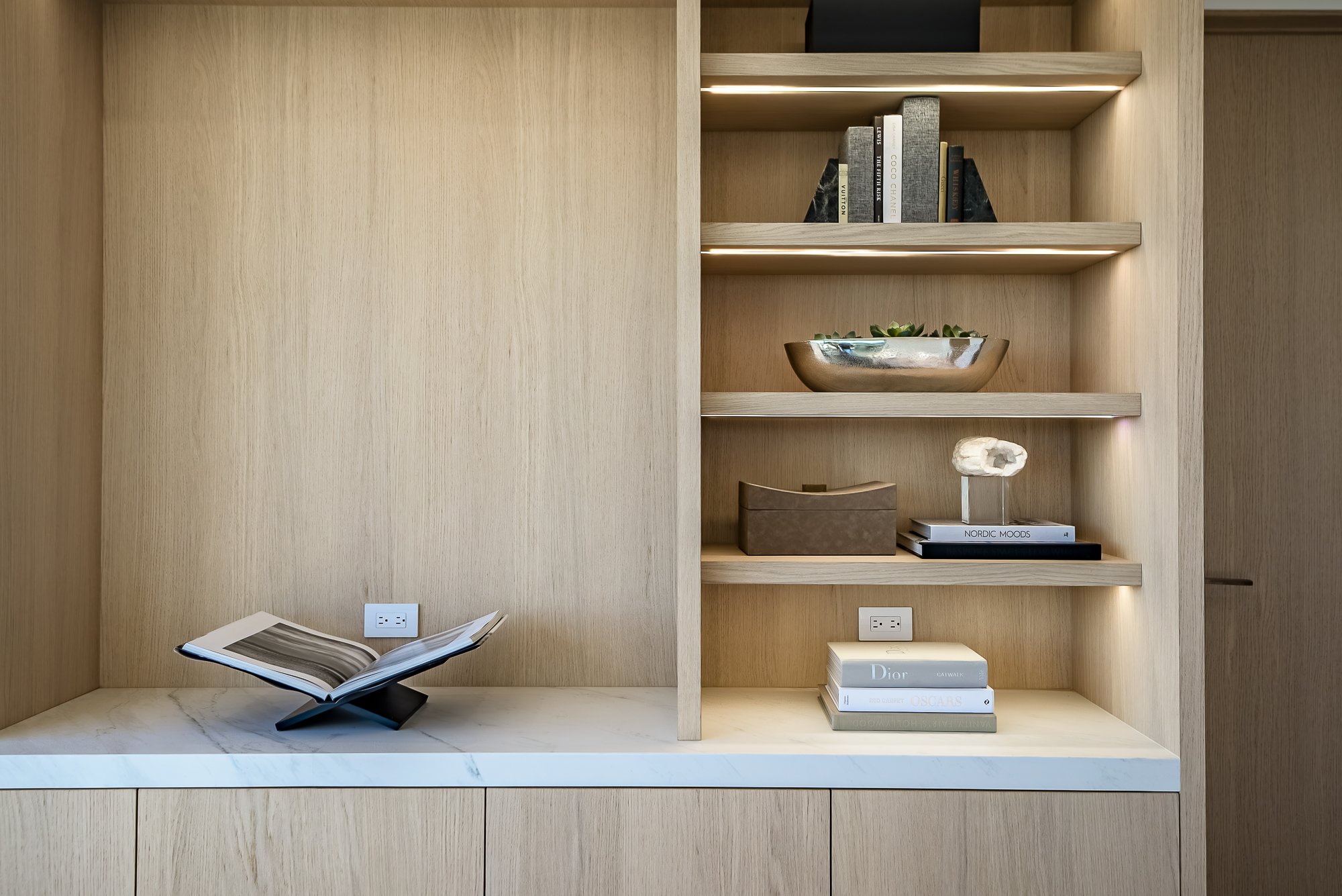 Custom home office cabinets with integrated lighting and book storage