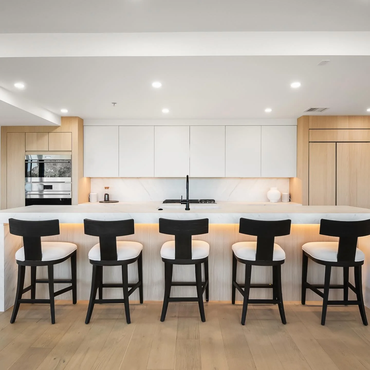 Are white cabinets out in 2026?

Not quite. But the era of the all white kitchen is definitely fading.

For years, bright white cabinetry dominated kitchen design. Now homeowners and designers are moving toward warmer, more layered spaces. Natural wo