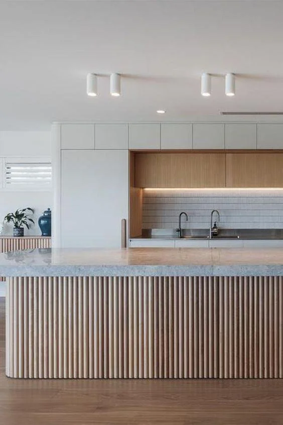 beautiful kitchen in luxury home with fluted white oak island