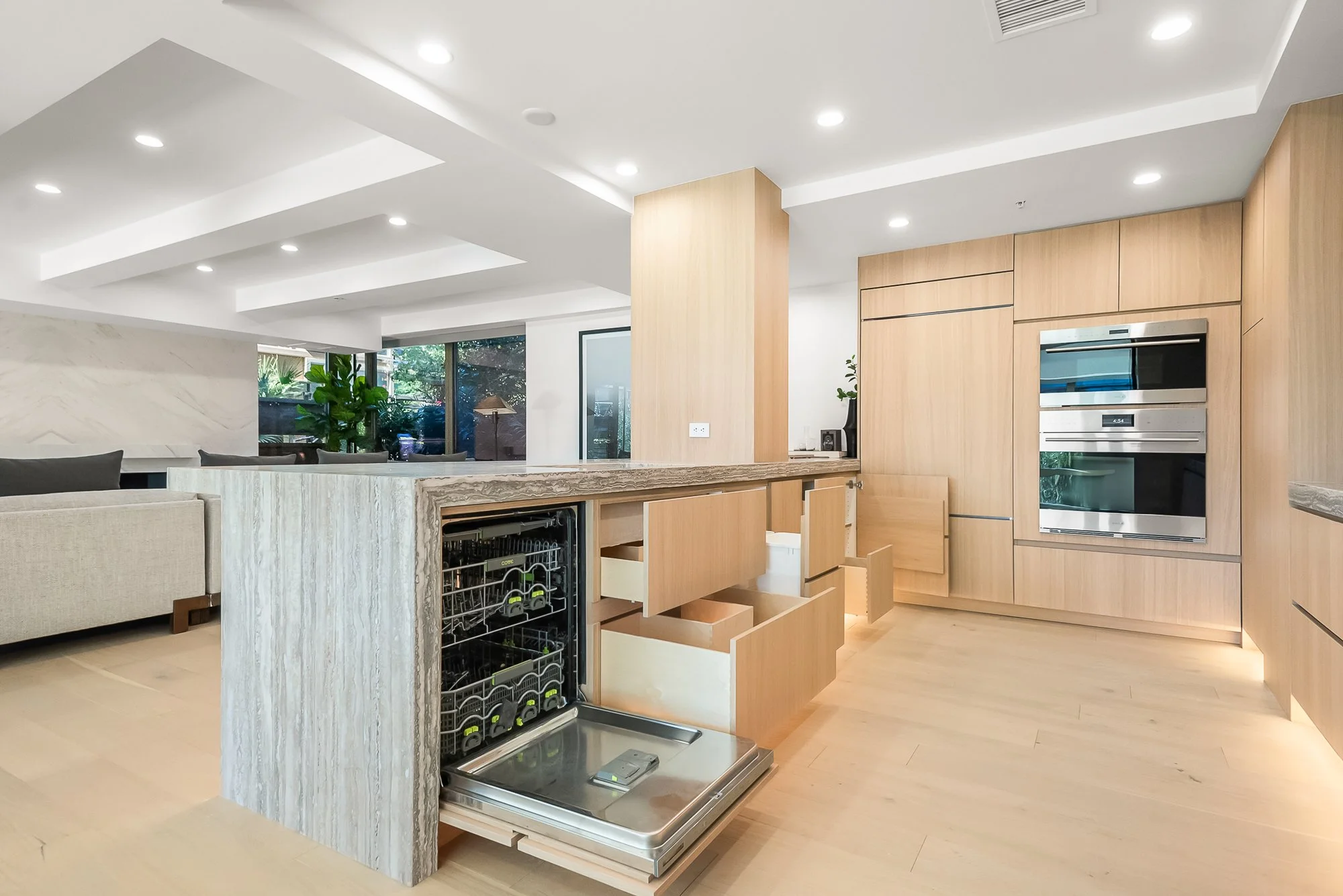 Premium custom cabinet interior with adjustable wood shelving, integrated lighting, and organized dish storage.