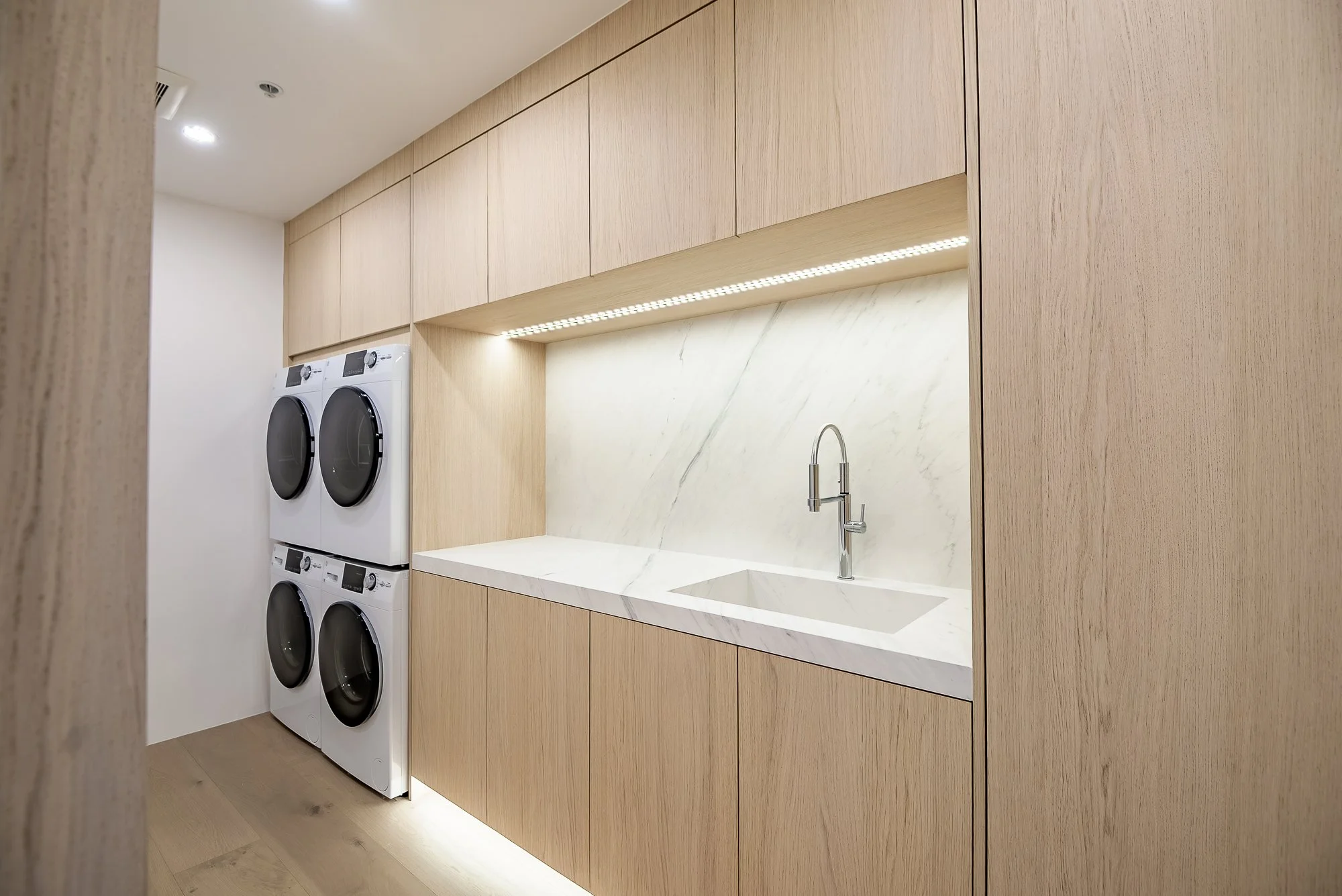 Custom-built laundry room with white oak cabinetry in a Scottsdale laundry room