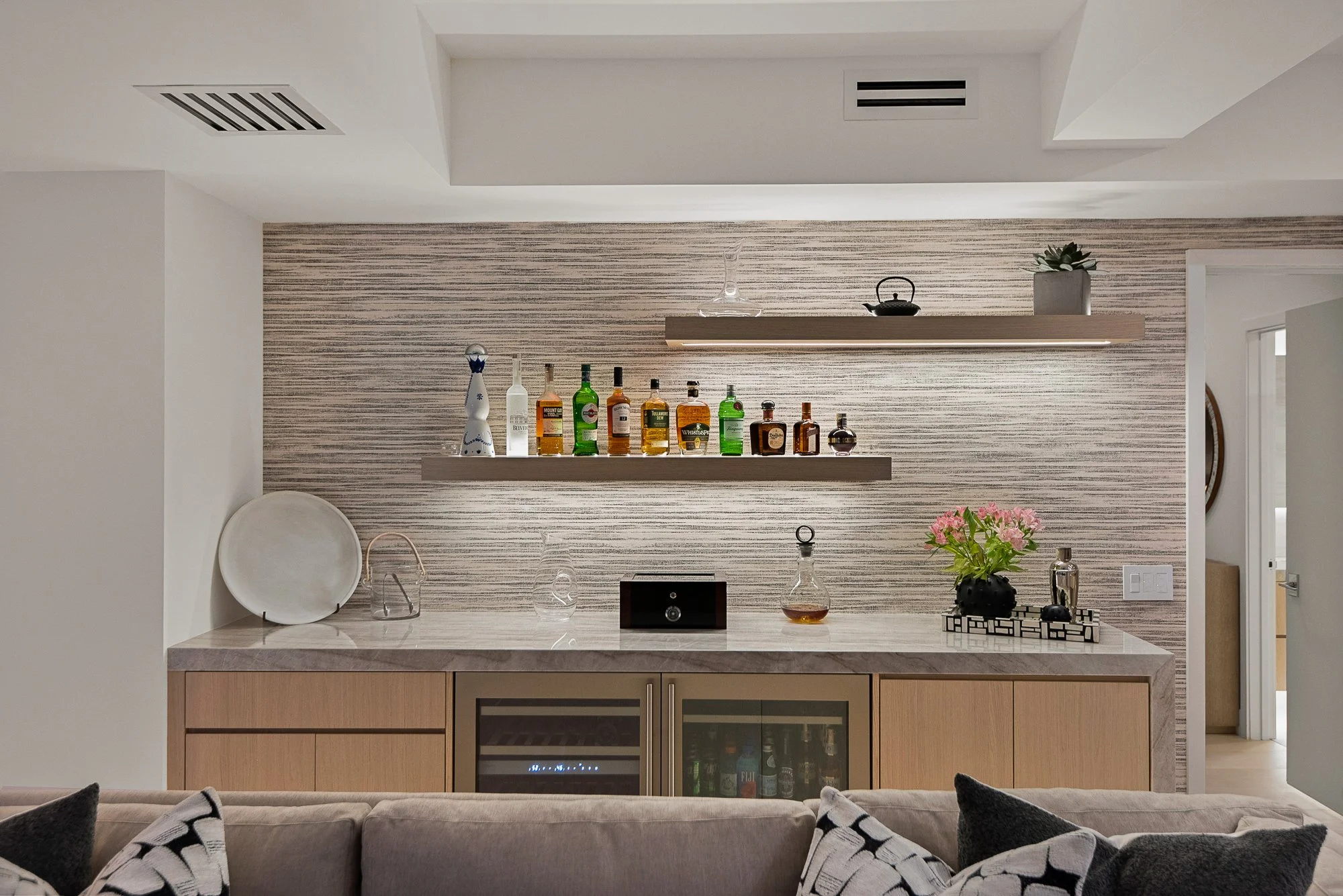 Elegant white oak dry bar with panel-ready wine and beverage coolers, glass cabinets, and built-in storage for barware and bottles