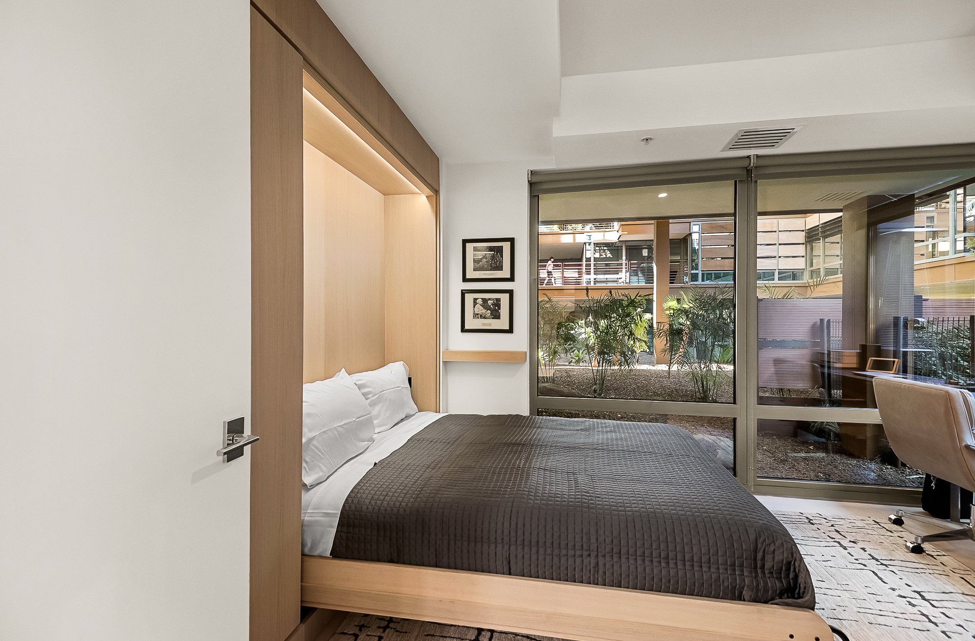 Custom-built Murphy bed with white oak cabinetry in a Scottsdale guest room