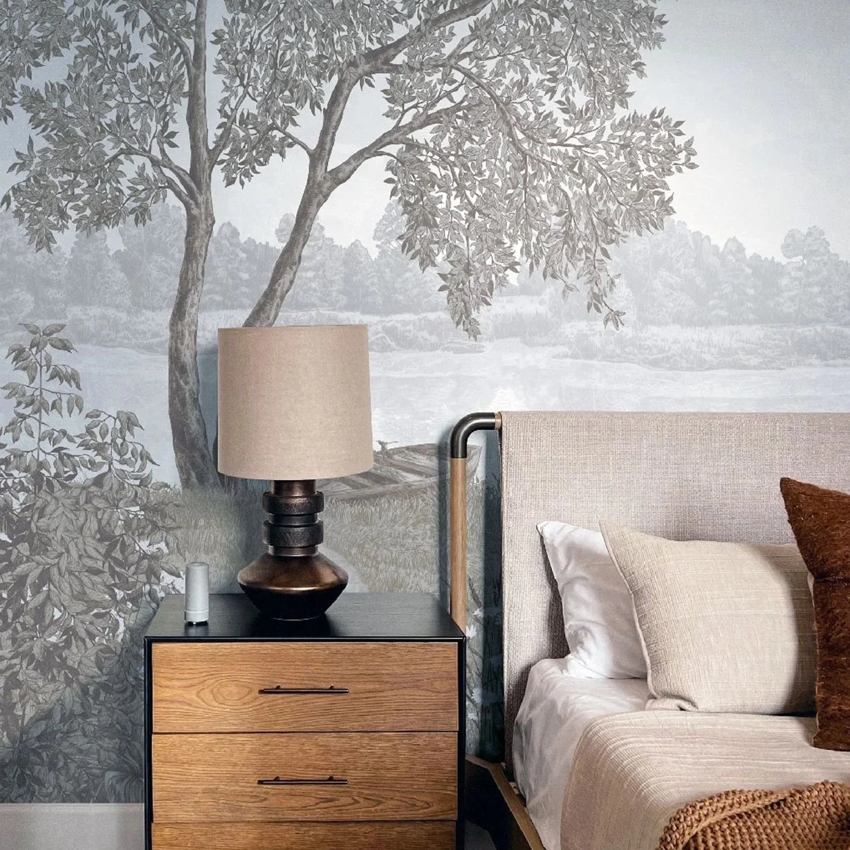 Large-scale botanical wallpaper mural with misty trees, landscape, and soft watercolor details in a cozy bedroom interior.Custom botanical wallpaper mural example - scalable panoramic patterns for interiors.