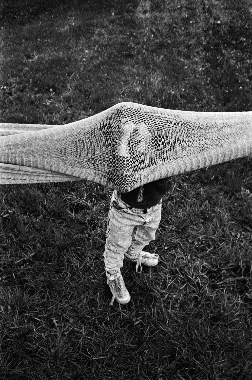 Boy standing underneath a net