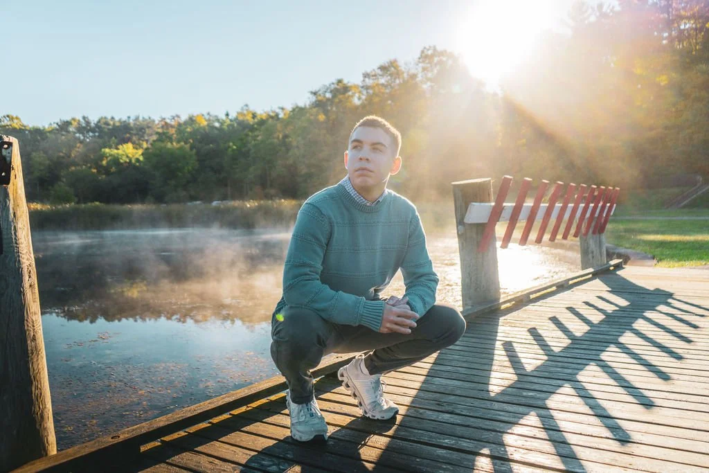 Senior pictures at Kendall Lake in Cuyahoga Valley National Park, with a young man beside the water