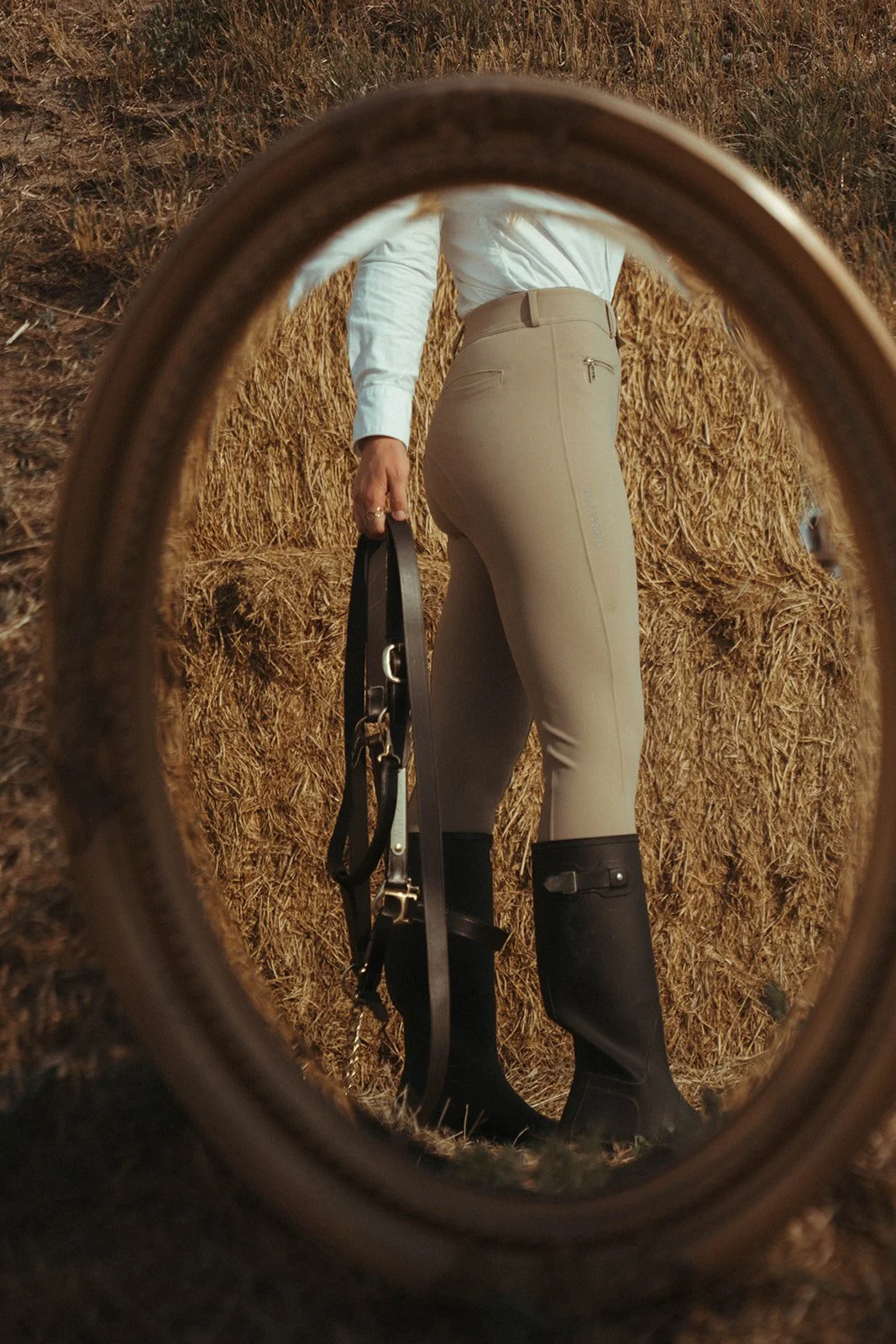 Equestrian product-style photographs featuring a halter and breeches in a beautiful outdoor setting, showcasing the product, equestrian lifestyle, and connection with the  horse life through natural, editorial-inspired imagery.
